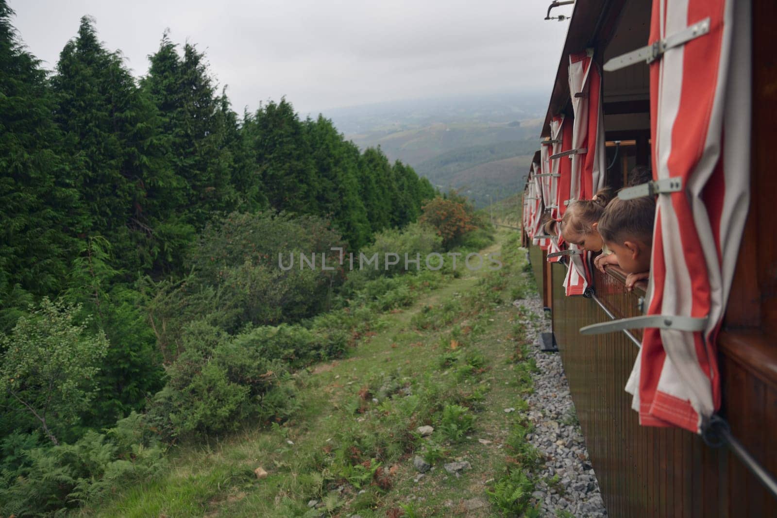 La Rhune cog train. Antique wooden train and kids in France