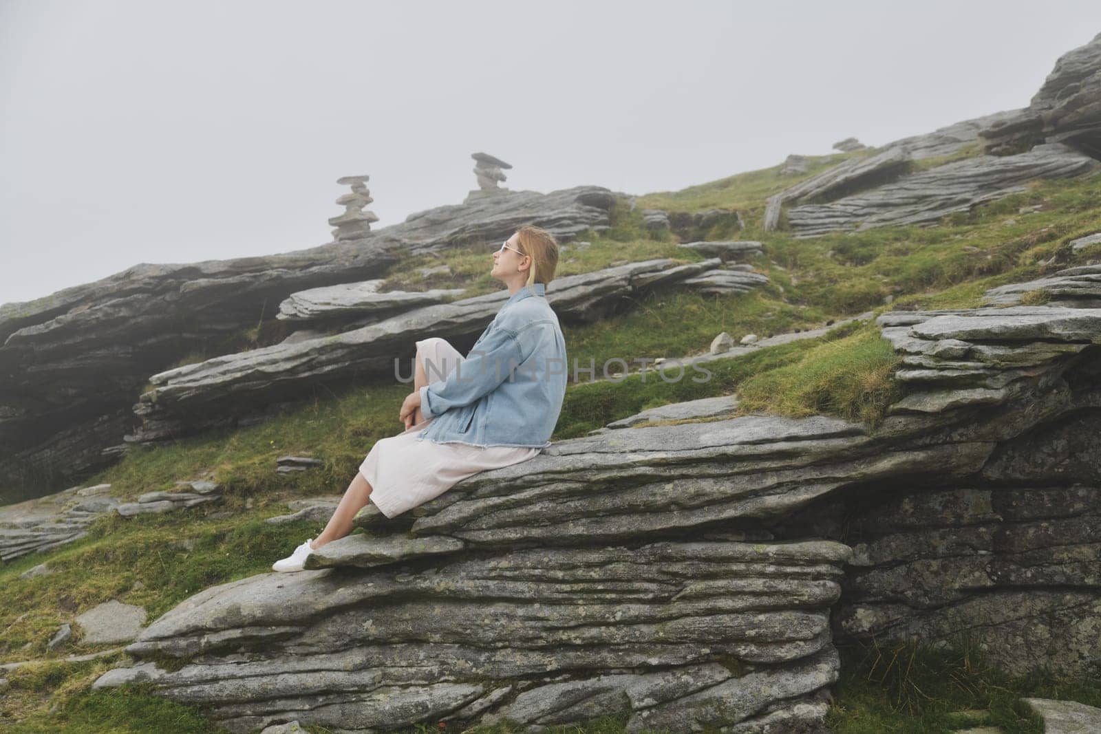 A woman hiking in the mountain at summer by Godi