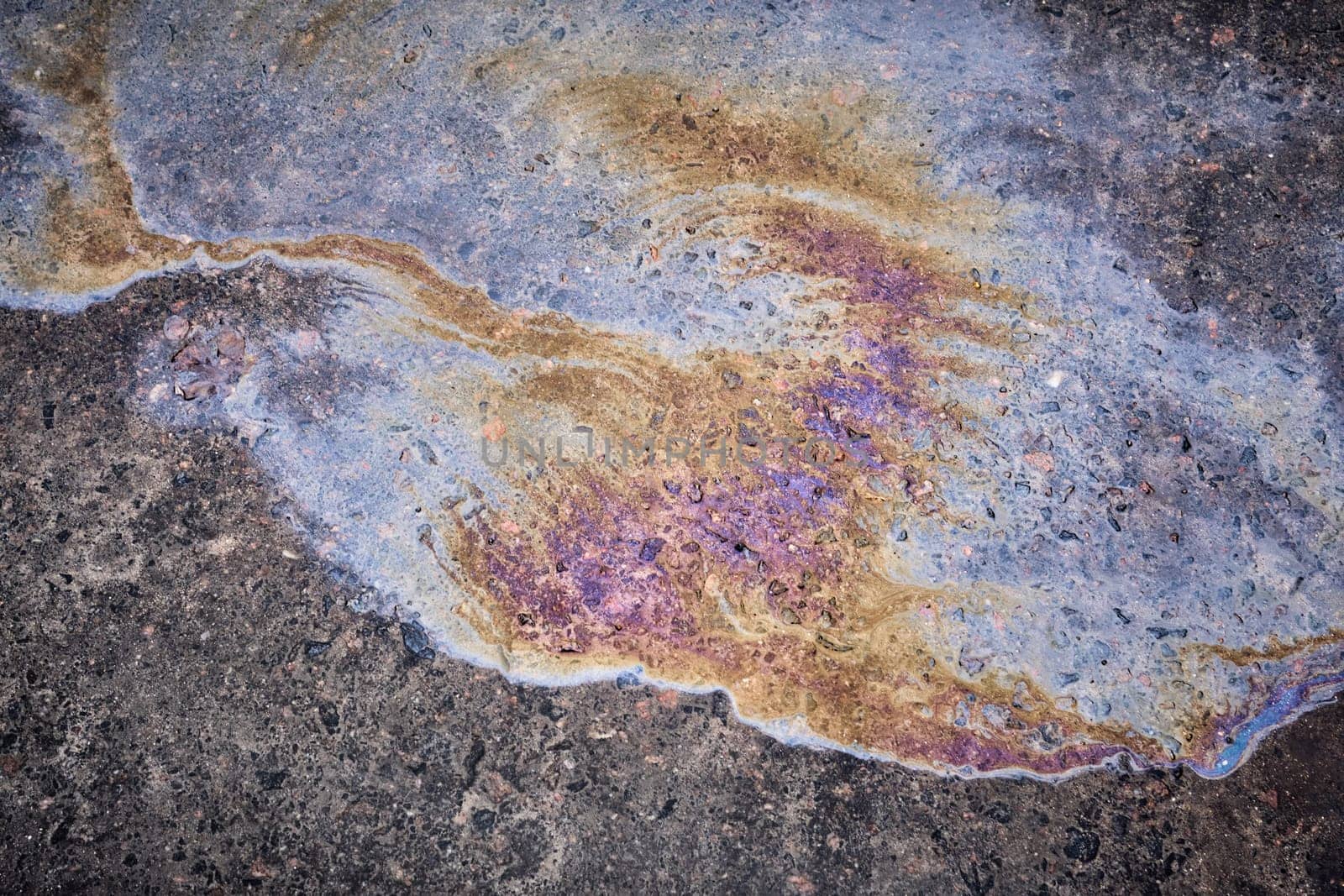 photography close-up of the asphalt road, which leaked old black oil from the car.