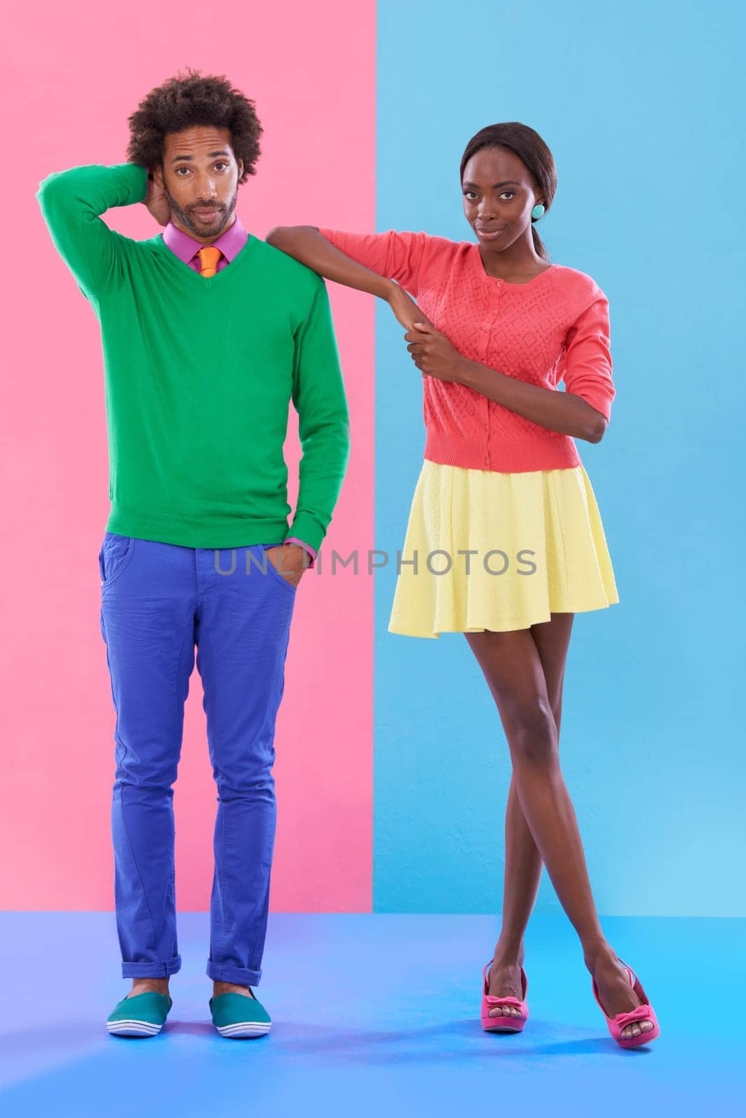Confused, couple and portrait with fashion in studio, background and creative aesthetic. Doubt, question and woman with support of man and together with colorful retro style and unique clothes mockup by YuriArcurs