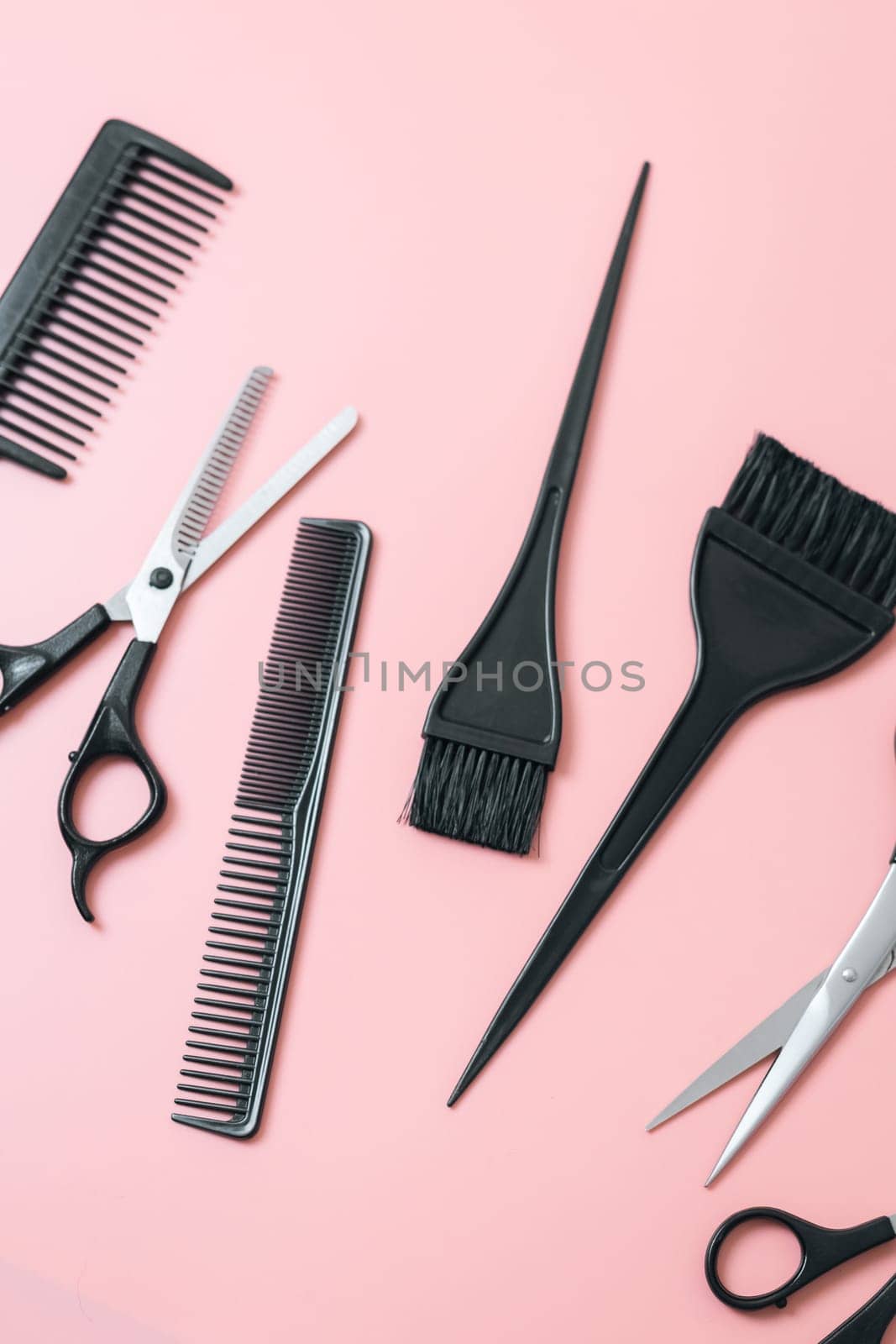 Set of hairdresser tools on a pink background. by Nataliya