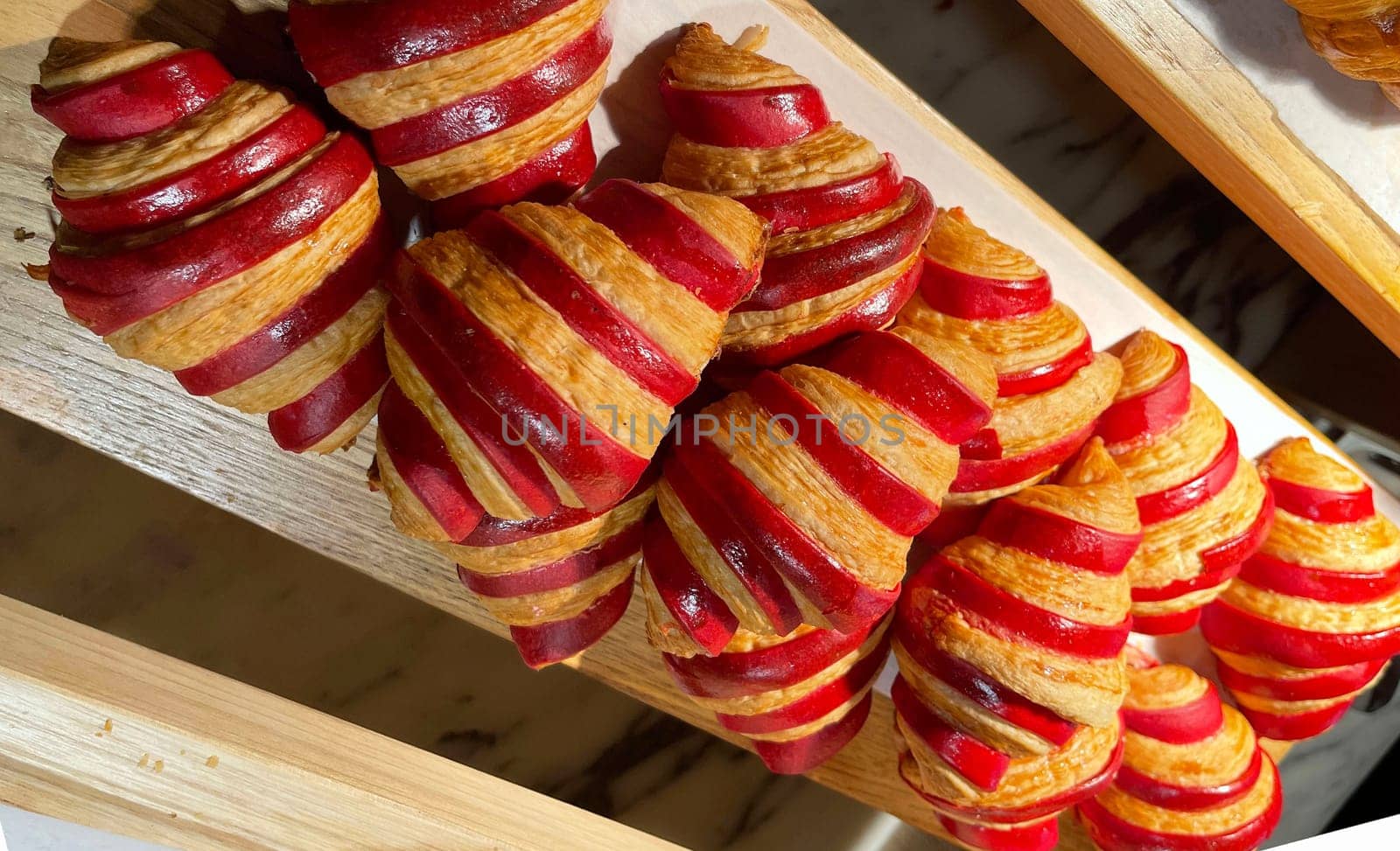 Close up of group of fresh baked delicious christmas croissants, super delicious warm fresh buttery Croissants and Rolls, French and American Croissants and baked pastries are enjoyed world wide on bakery shop, tasty multiple croissant