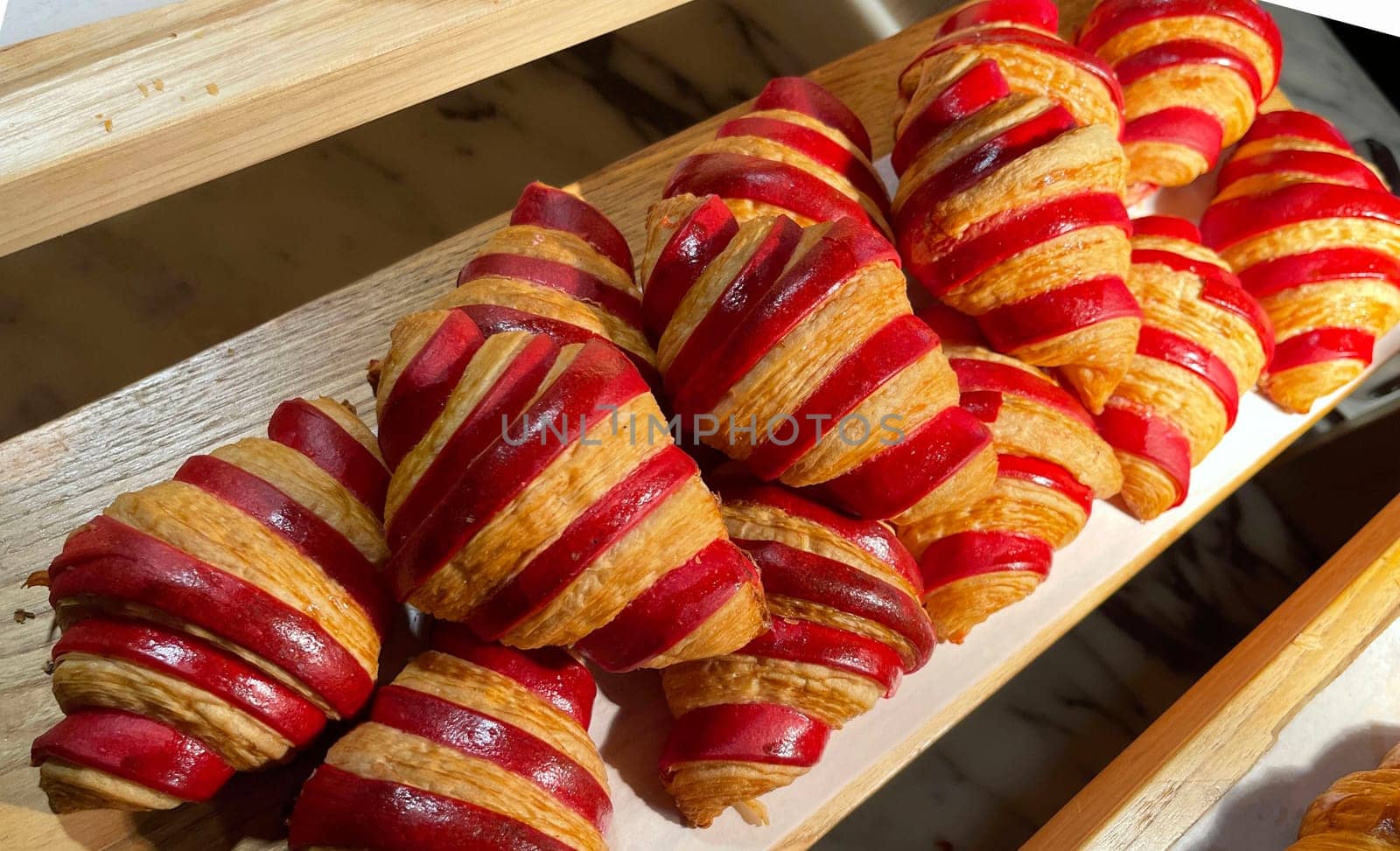 Close up of group of fresh baked delicious christmas croissants, super delicious warm fresh buttery Croissants and Rolls, French and American Croissants and baked pastries are enjoyed world wide on bakery shop, tasty multiple croissant