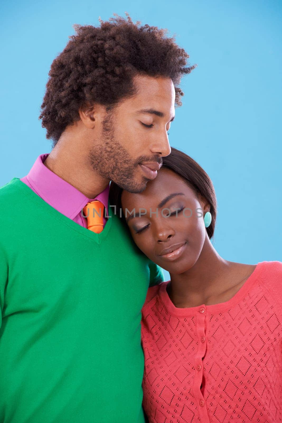 Hug, love and black couple with marriage, happy and romance on a blue studio background. Relationship, embrace and man with woman and peace with fashion and bonding together with a date and care.