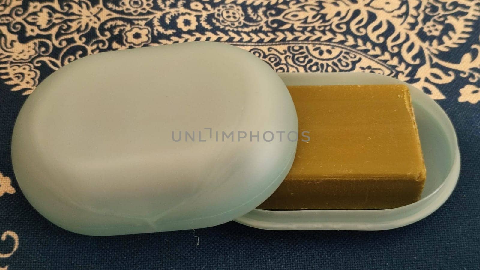 natural soap with olive oil, blue plastic soap dish, objects. High quality photo