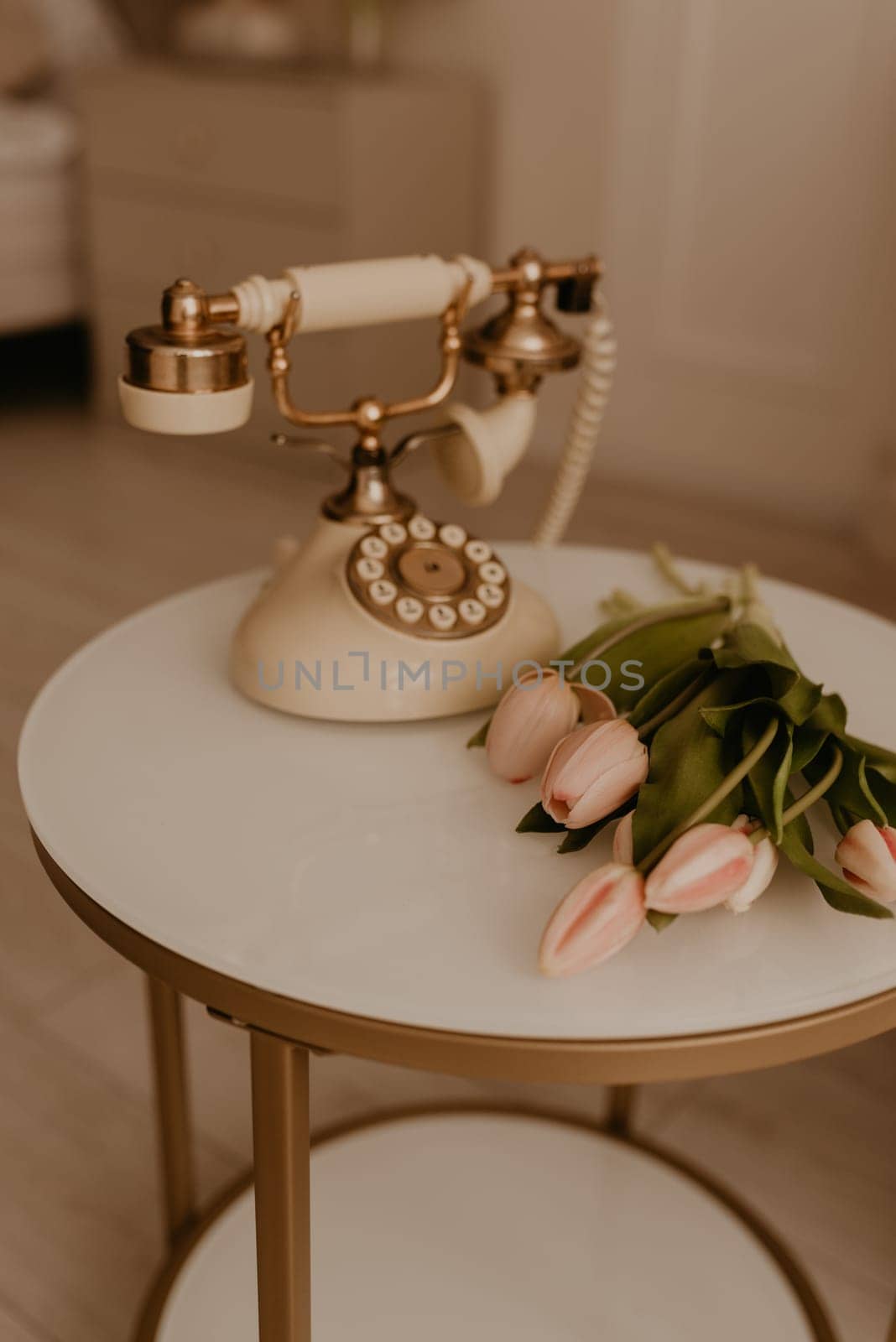 rare phone exquisite vintage decorated with gold fresh pastel flowers tulips. furniture, design solutions. details in interior decoration for home.holiday March 8, International Women Day, gift