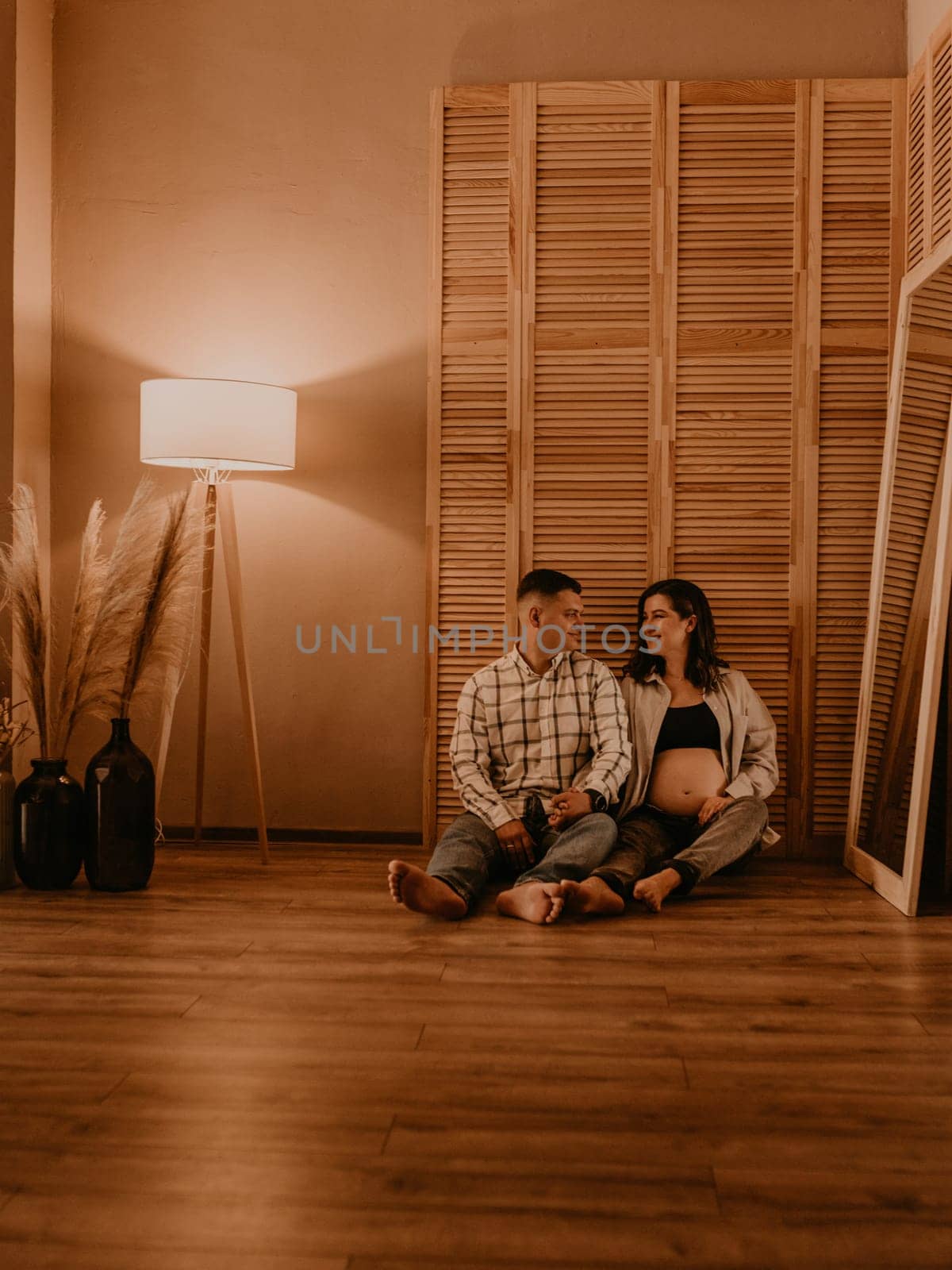 an incredibly beautiful married couple Expecting child, pregnant wife. Happy parenthood, real Ukrainian young family. romantic, gentle, stylish photo session of married couple. pregnant woman in love