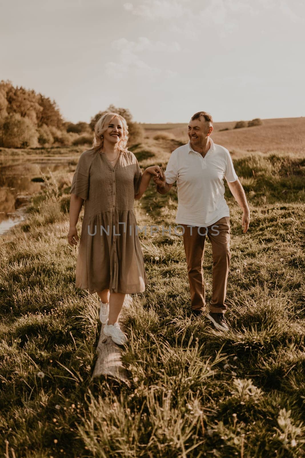 happy married couple mature people together for long time, secret of strong family relationships, cheerful joyful husband and wife together in harmony. middle-aged couple walking in nature at summer