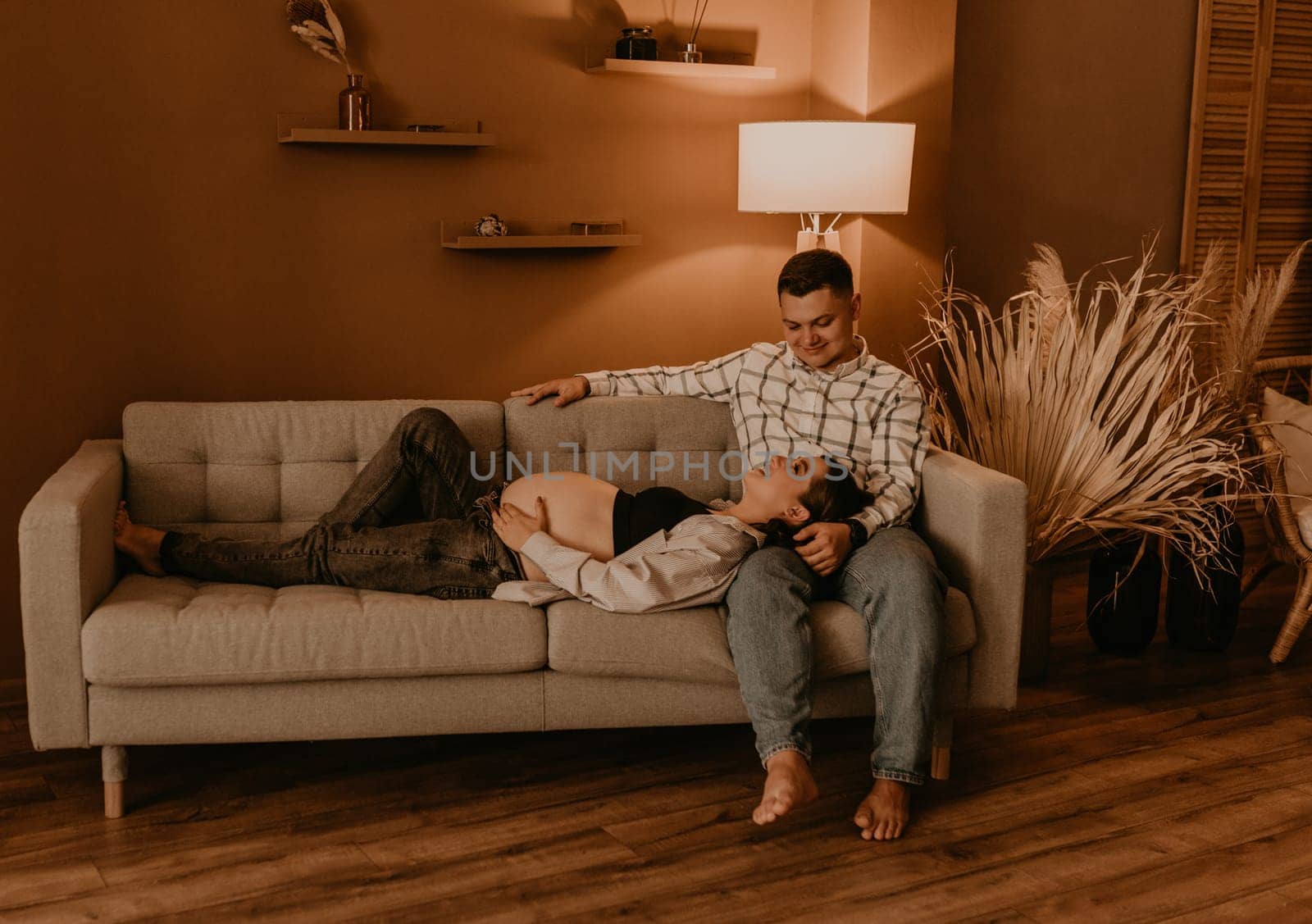 an incredibly beautiful married couple Expecting child, pregnant wife. Happy parenthood, real Ukrainian young family. romantic, gentle, stylish photo session of married couple. pregnant woman in love