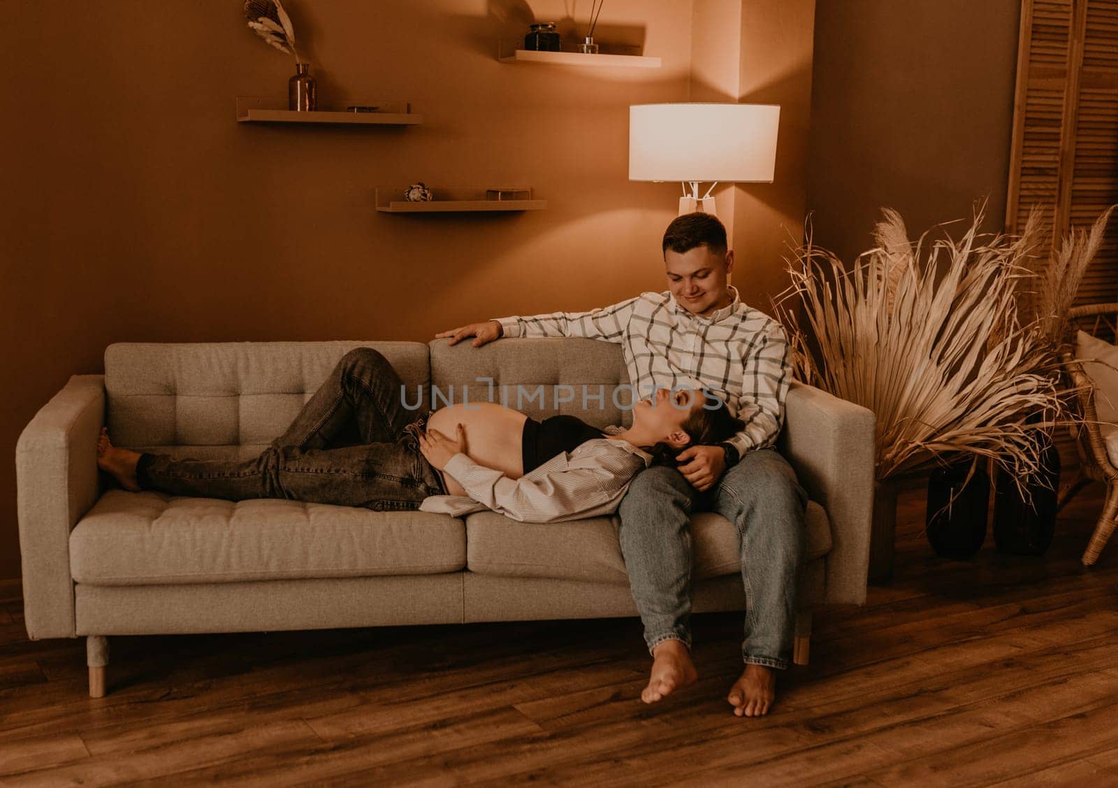 an incredibly beautiful married couple Expecting child, pregnant wife. Happy parenthood, real Ukrainian young family. romantic, gentle, stylish photo session of married couple. pregnant woman in love