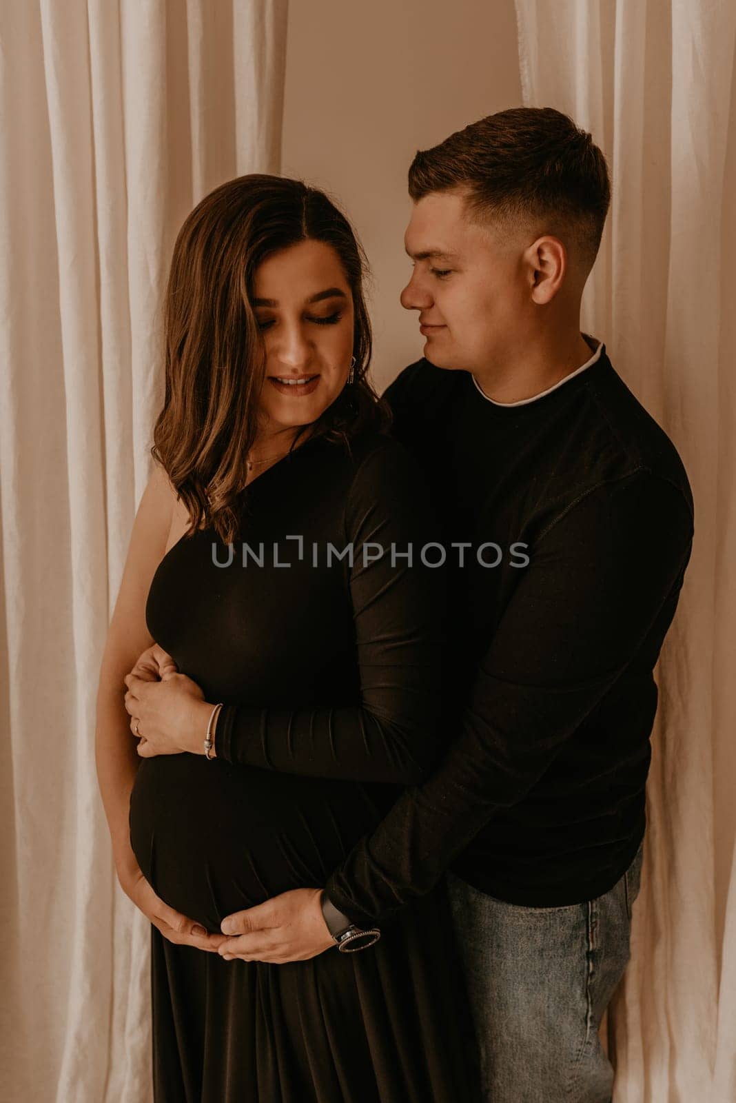 an incredibly beautiful married couple Expecting child, pregnant wife. Happy parenthood, real Ukrainian young family. romantic, gentle, stylish photo session of married couple. pregnant woman in love