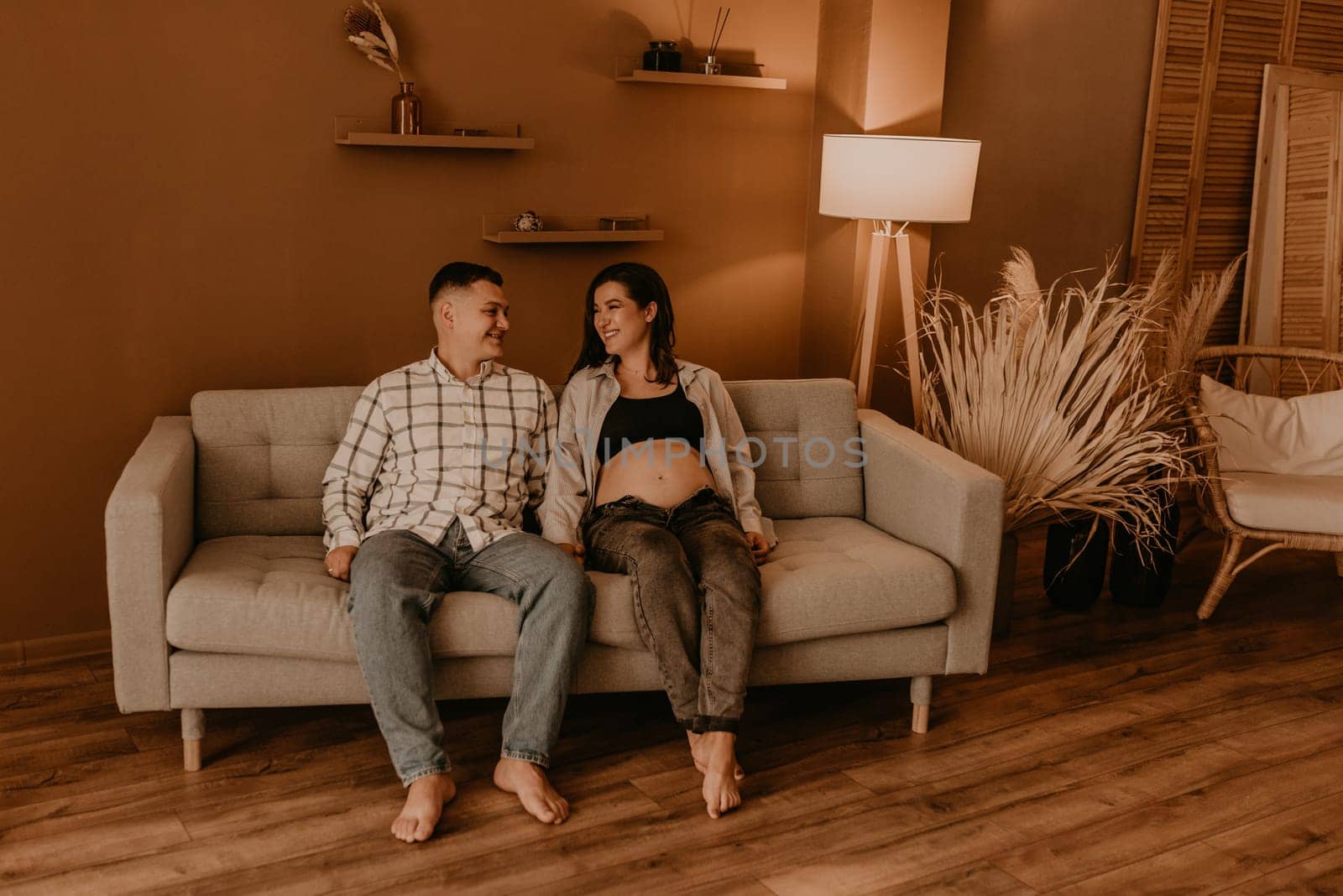 an incredibly beautiful married couple Expecting child, pregnant wife. Happy parenthood, real Ukrainian young family. romantic, gentle, stylish photo session of married couple. pregnant woman in love