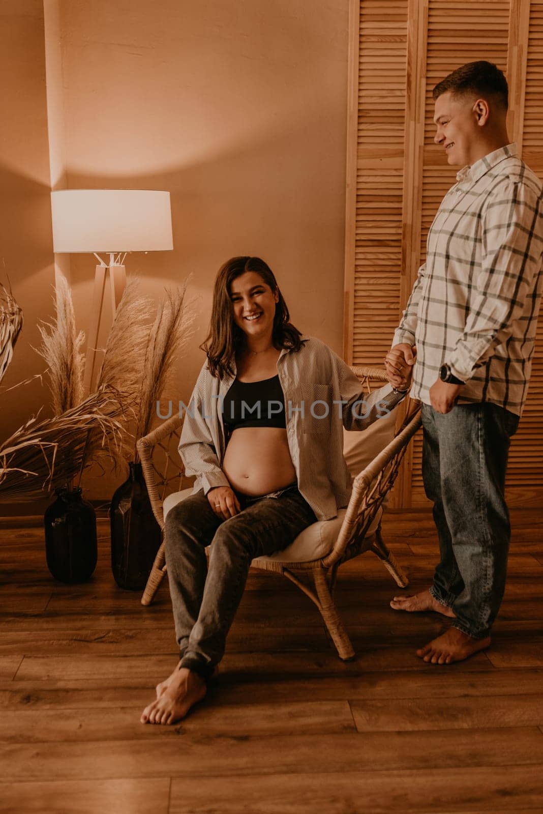 an incredibly beautiful married couple Expecting child, pregnant wife. by AndriiDrachuk