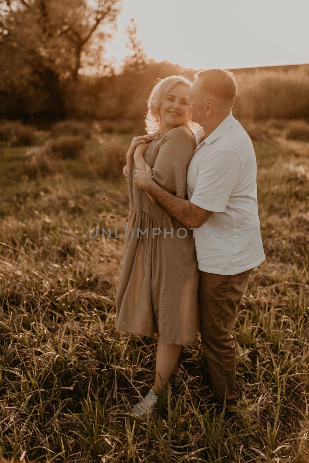 happy married couple mature people together for long time, secret of strong family relationships, cheerful joyful husband and wife together in harmony. middle-aged couple walking in nature at summer