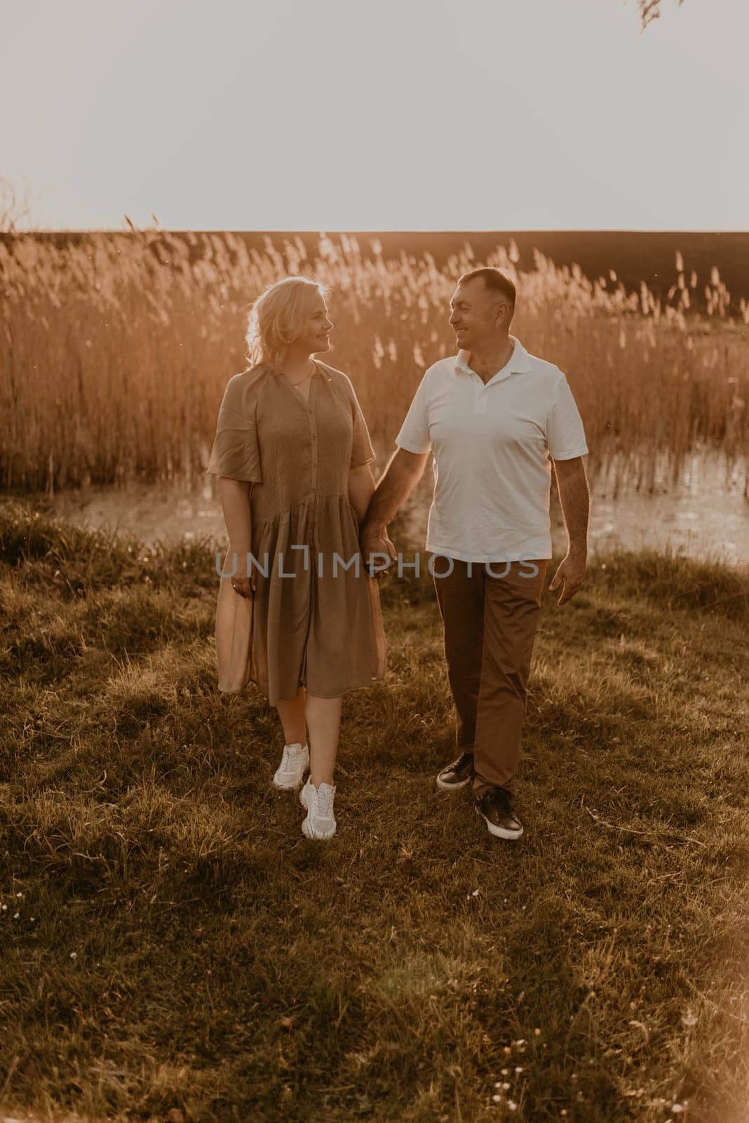 happy married couple mature people together for long time, secret of strong family relationships, cheerful joyful husband and wife together in harmony. middle-aged couple walking in nature at summer