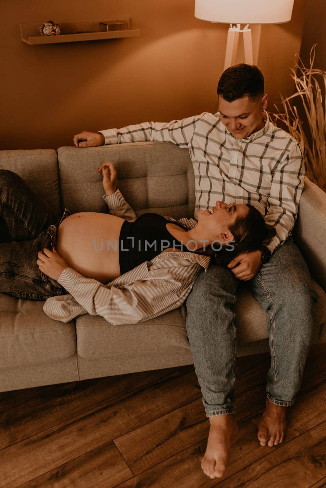 an incredibly beautiful married couple Expecting child, pregnant wife. Happy parenthood, real Ukrainian young family. romantic, gentle, stylish photo session of married couple. pregnant woman in love