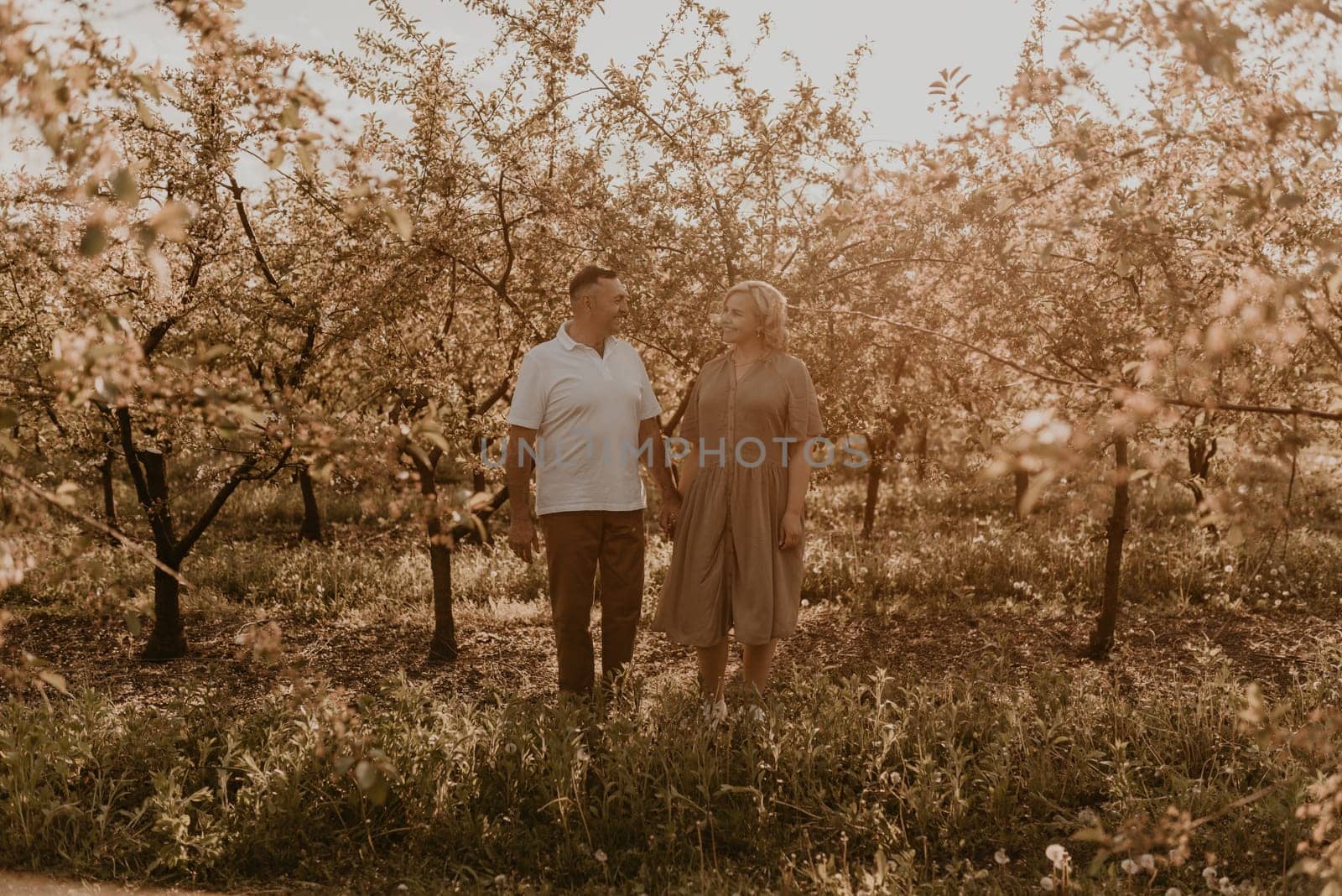 happy married couple mature people together for long time, secret of strong family relationships, cheerful joyful husband and wife together in harmony. middle-aged couple walking in nature at summer