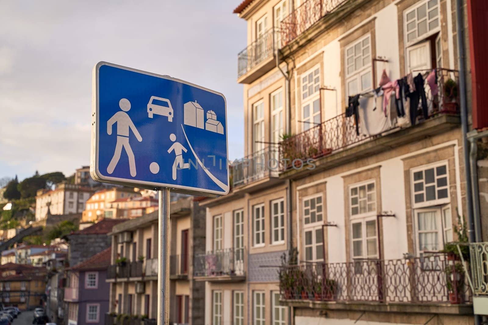 Home zone road sign in Porto, Protugal on old houses background by berezko