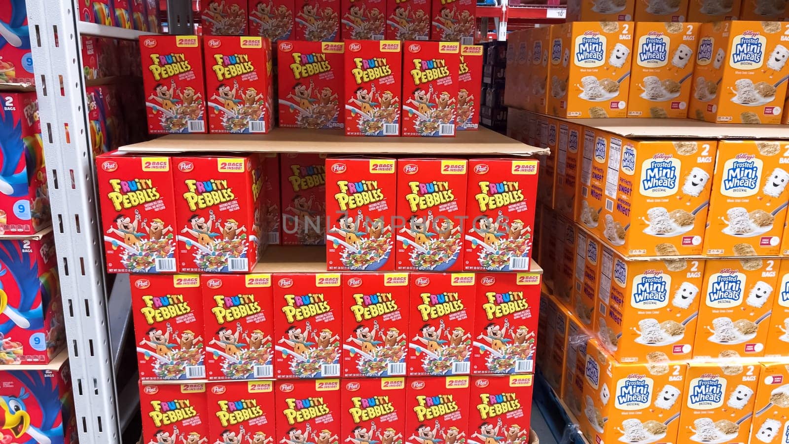 Denver, Colorado, USA-February 28, 2024-The vibrant red boxes of Fruity Pebbles cereal create a striking display on the supermarket shelf, inviting shoppers to add a classic, fruity breakfast treat to their carts.
