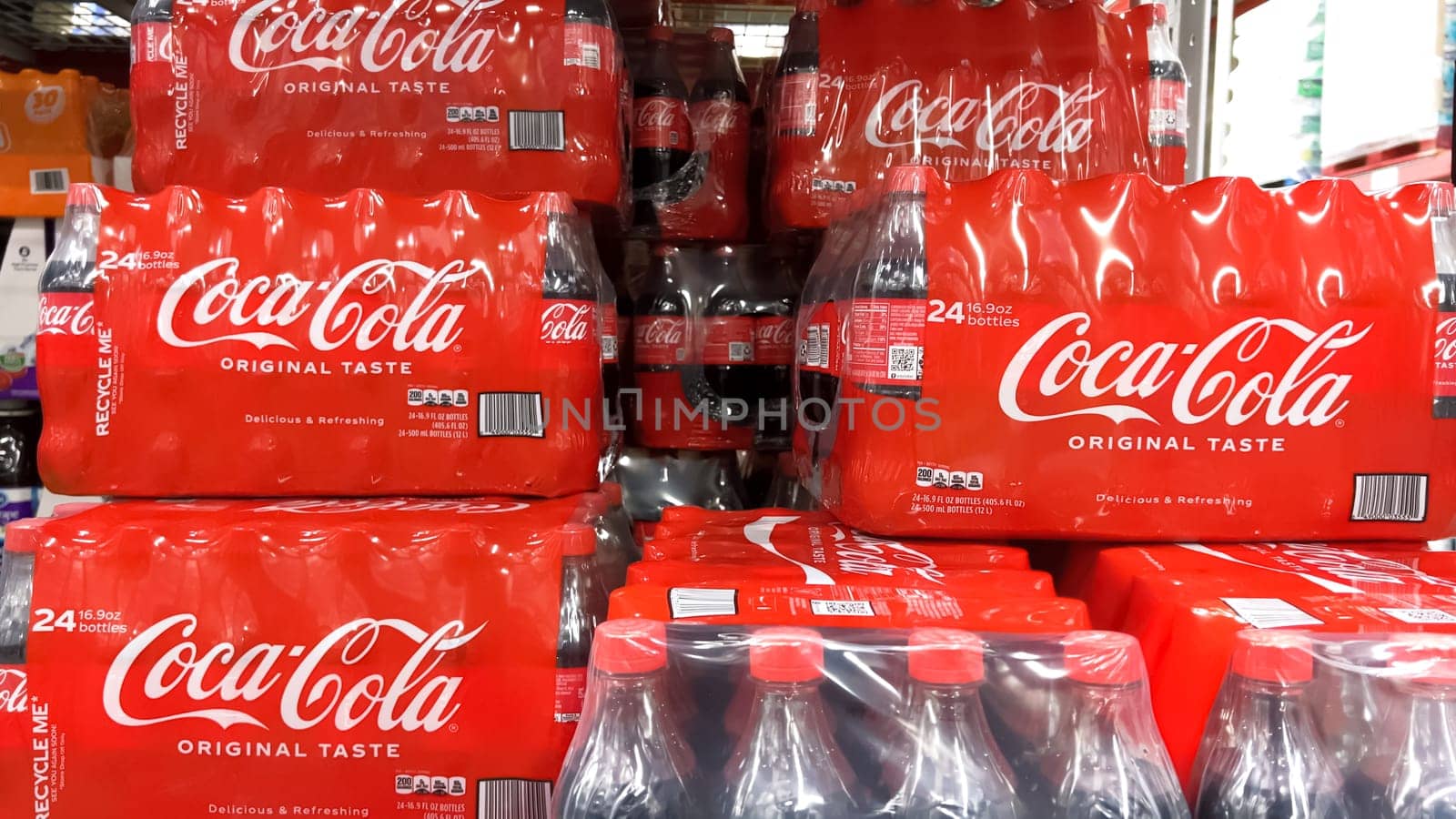 Denver, Colorado, USA-February 28, 2024-At Sam’s Club, the shelves are stocked with bulk multipacks of Coca-Cola Original Taste, their iconic red branding a familiar sight, ready for members to enjoy the classic flavor.