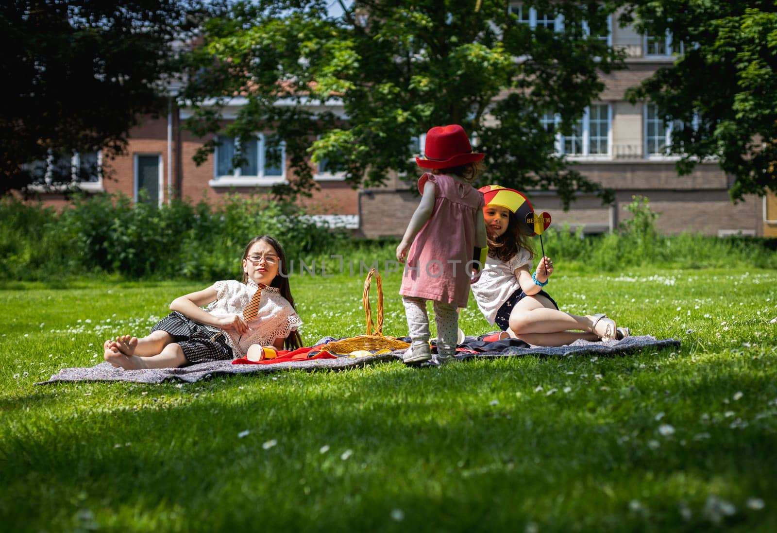 Portrait of three girls in the park at a picnic. by Nataliya