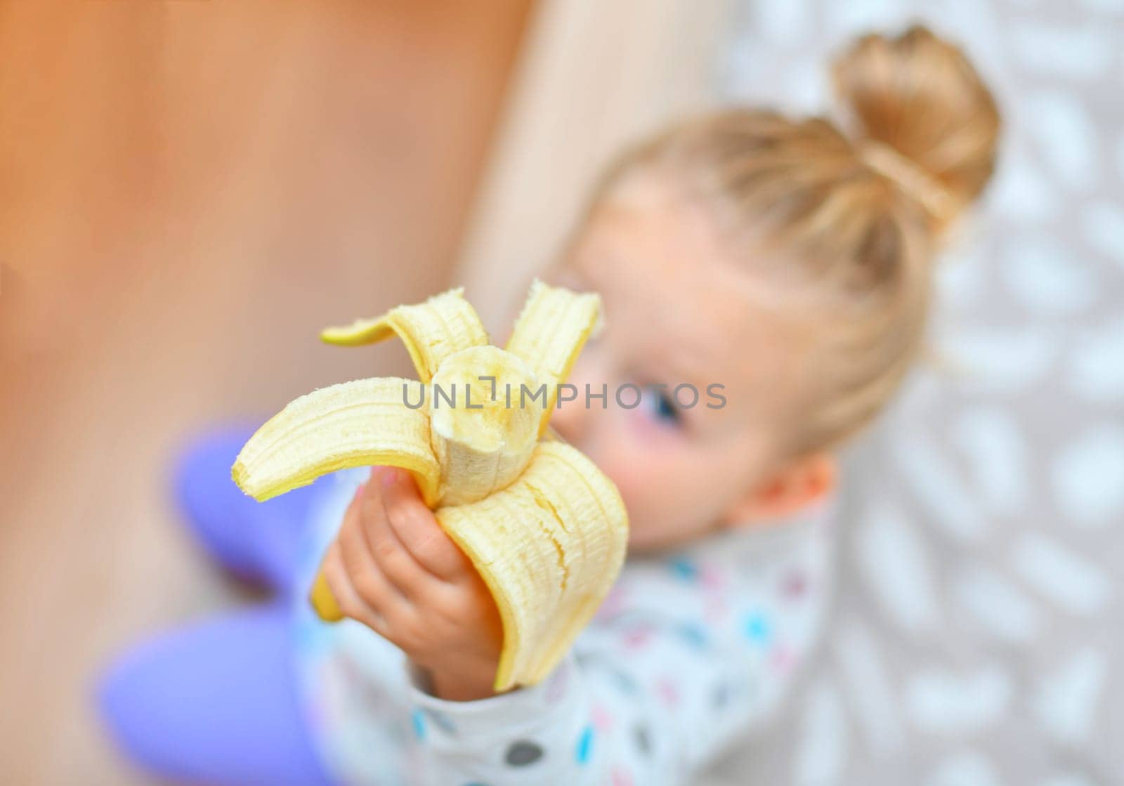 Girl holds banana in her hands