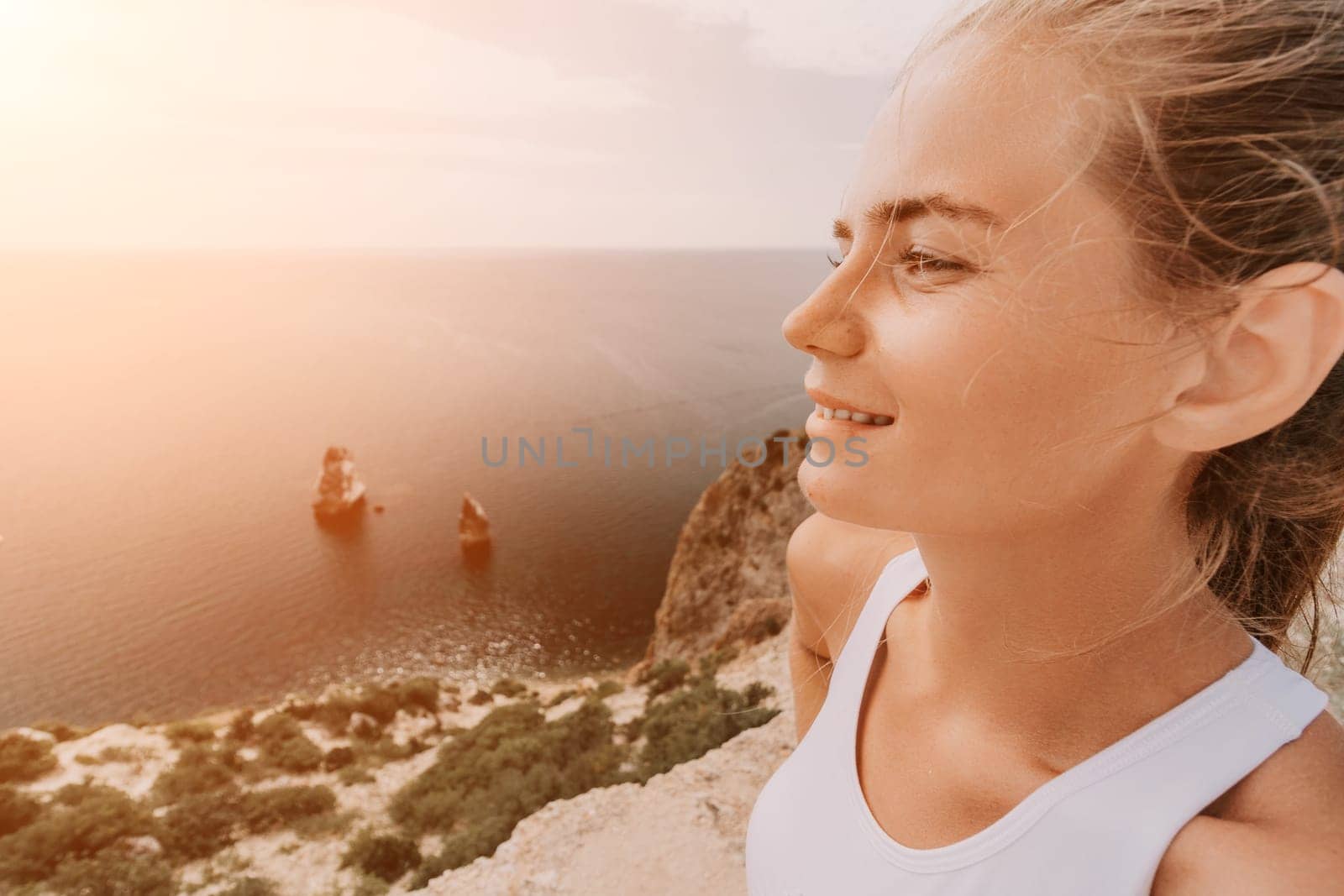 Woman travel sea. Young Happy woman posing on a beach over the sea on background of volcanic rocks, like in Iceland, sharing travel adventure journey by panophotograph