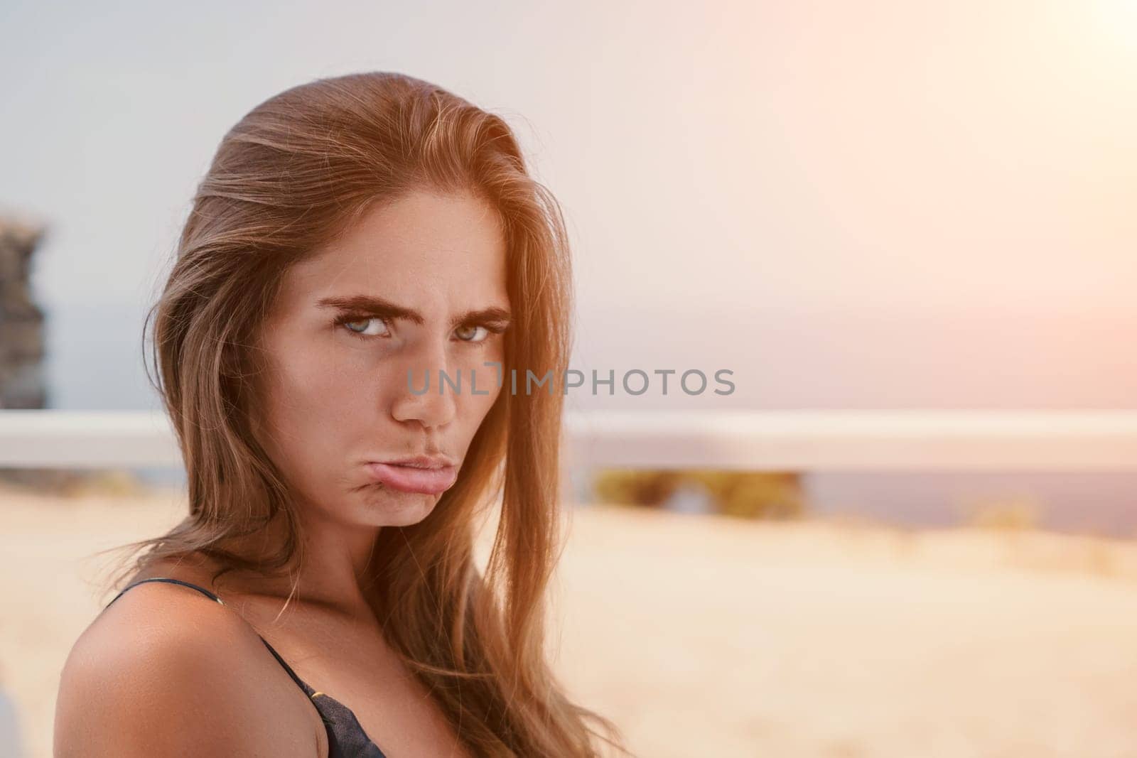 Happy woman portrait in cafe. Boho chic fashion style. Outdoor photo of young happy woman with long hair, sunny weather outdoors sitting in modern cafe