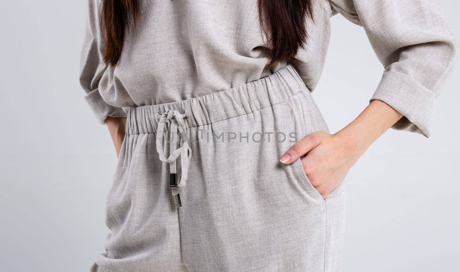 Model in elegant linen pantsuit, perfect for casual or smart-casual office looks. Breathable, lightweight fabric ideal for warm weather. Available in various colors to match your style.