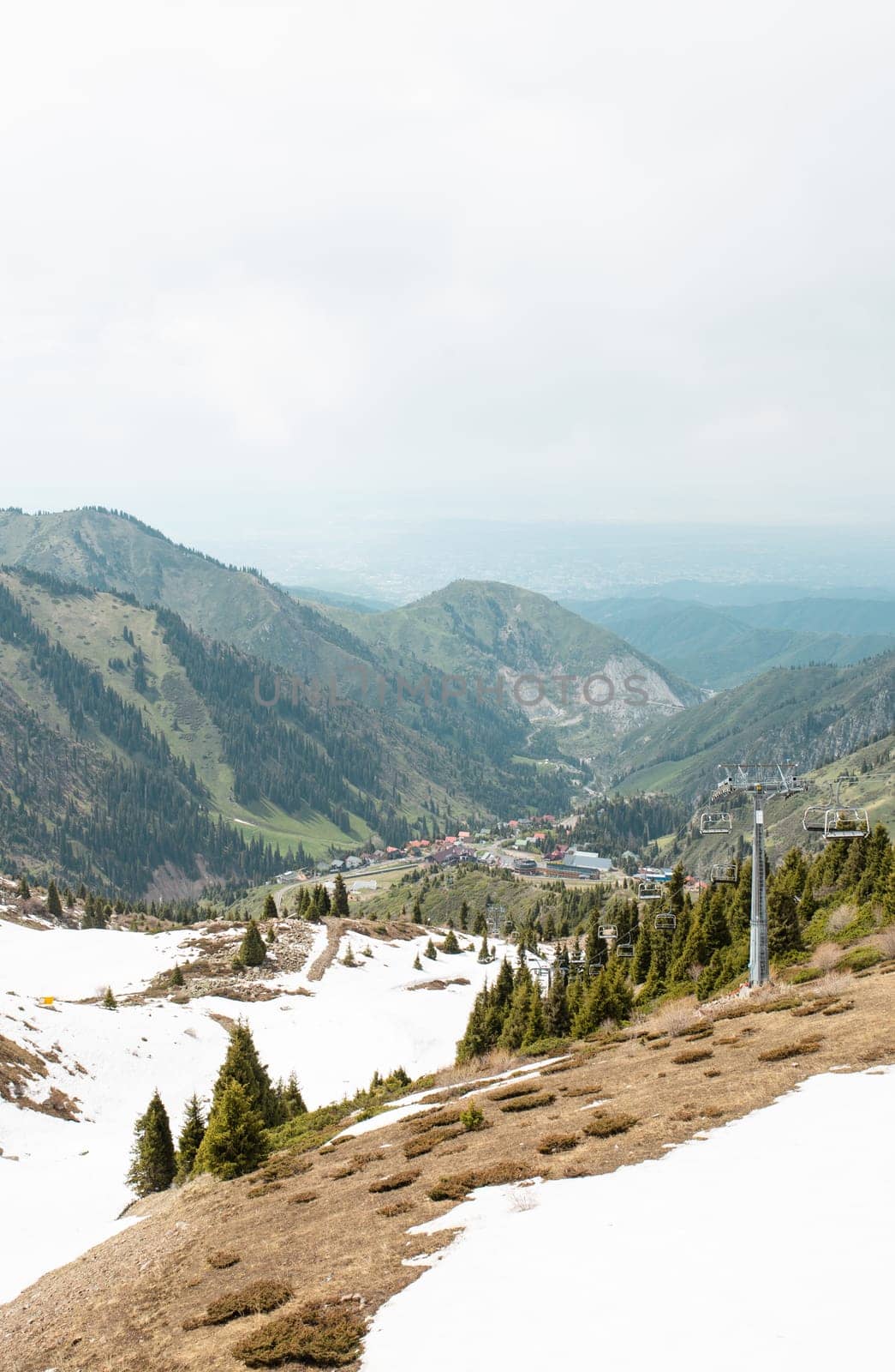 Picturesque Mountain Landscape with Lush Greenery and Snow-capped Peaks in the Distance by Pukhovskiy