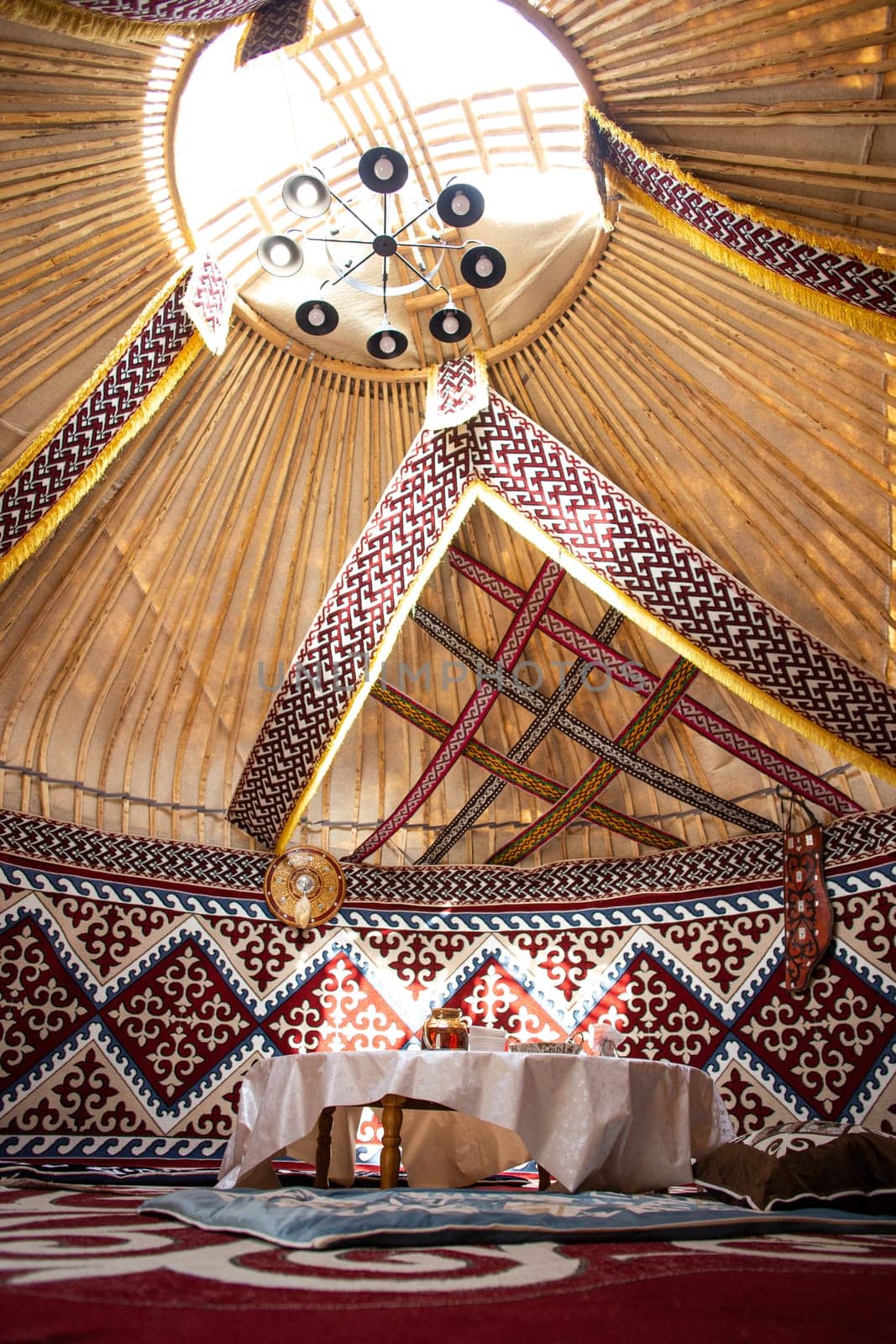 Kazak yurt interior with traditional felt carpets and furniture by Pukhovskiy