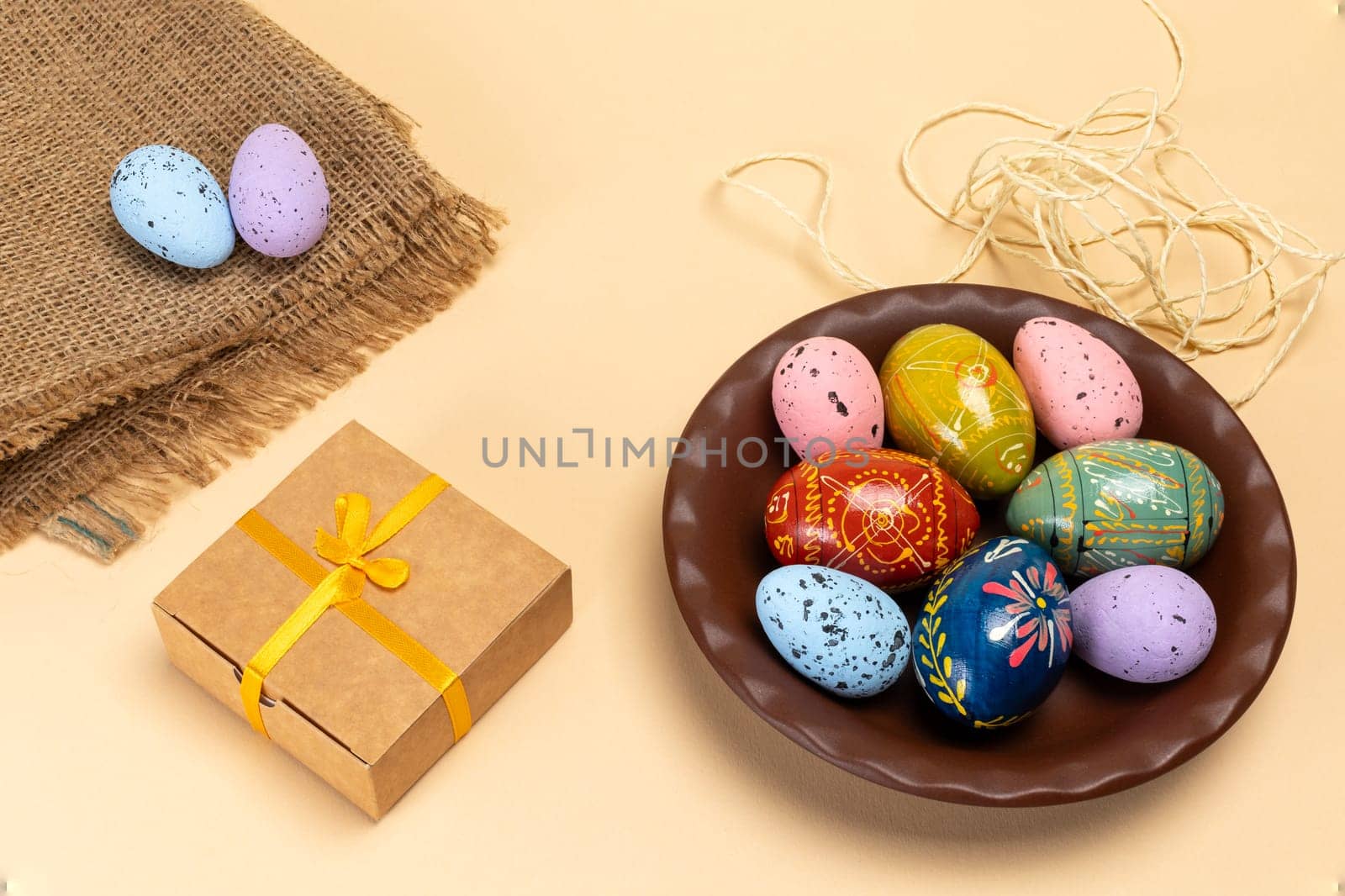 Plate with colored Easter eggs and a gift box. by mvg6894