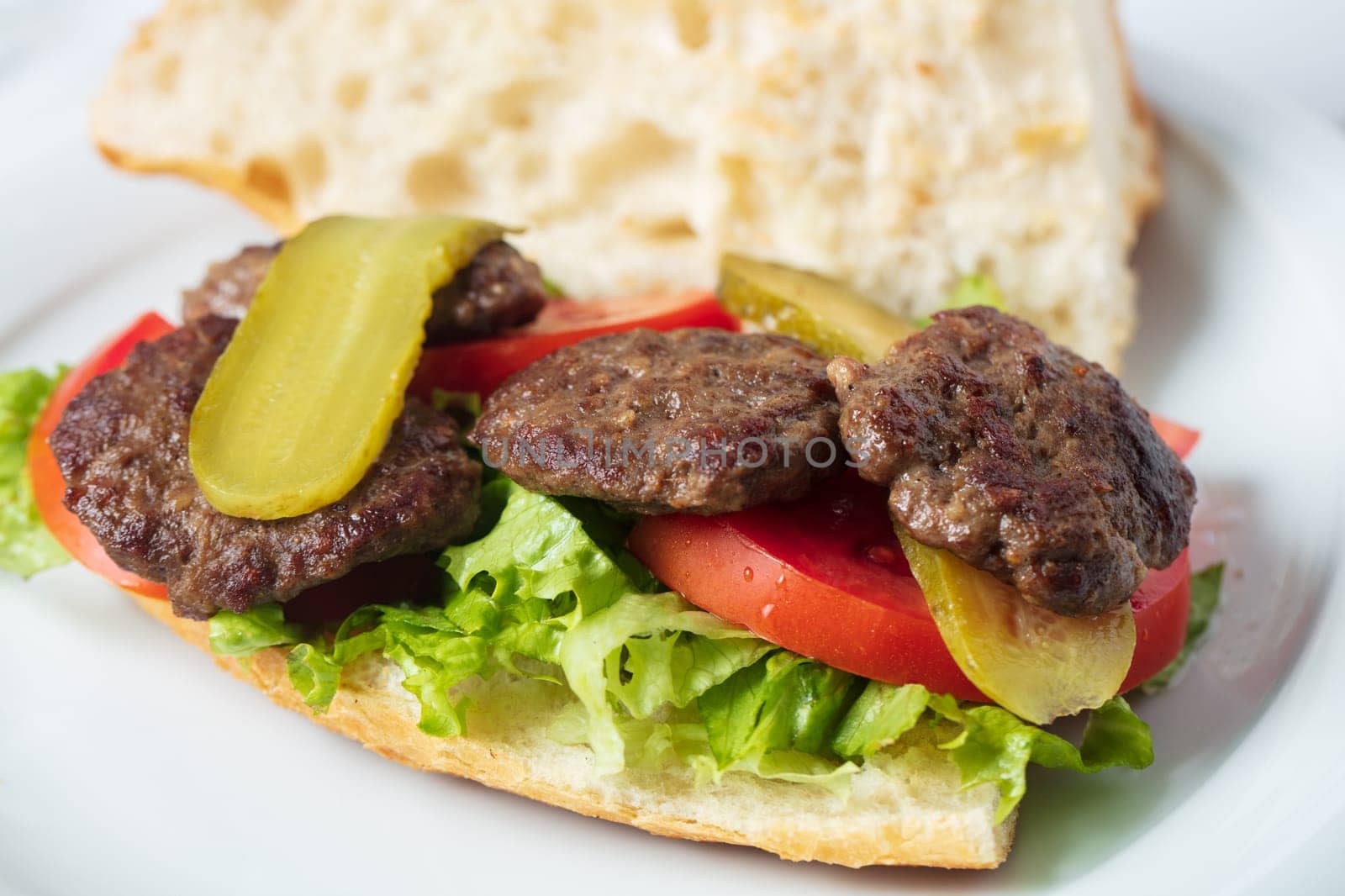 Traditional Turkish meatballs served with French fries tomatoes . High quality photo