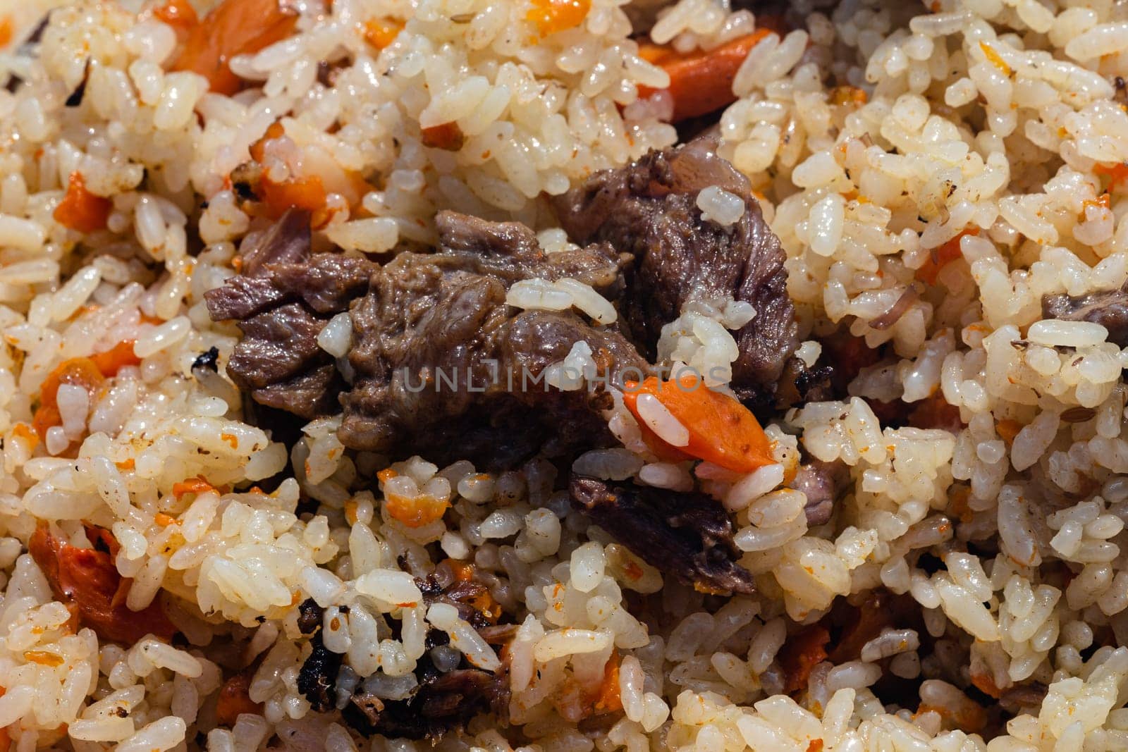 Traditional Eastern culinary dish - pilaf. Ingredients: rice with slices of meat by Alexander-Piragis