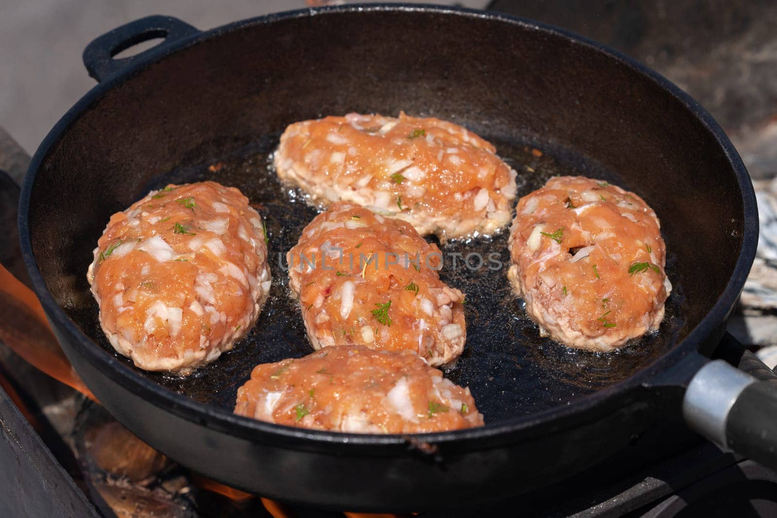 Delicious wild red salmon fish cutlets fried in hot griddle roast on coals by Alexander-Piragis