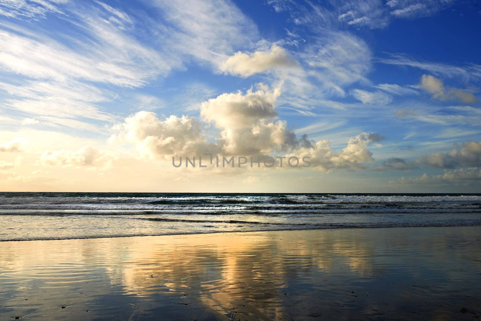 Sunset, beach and clouds on landscape in nature, evening sun and calm ocean with blue sky. Waves, summer skyline and peaceful environment with island sand, zen location and vacation horizon in Miami.