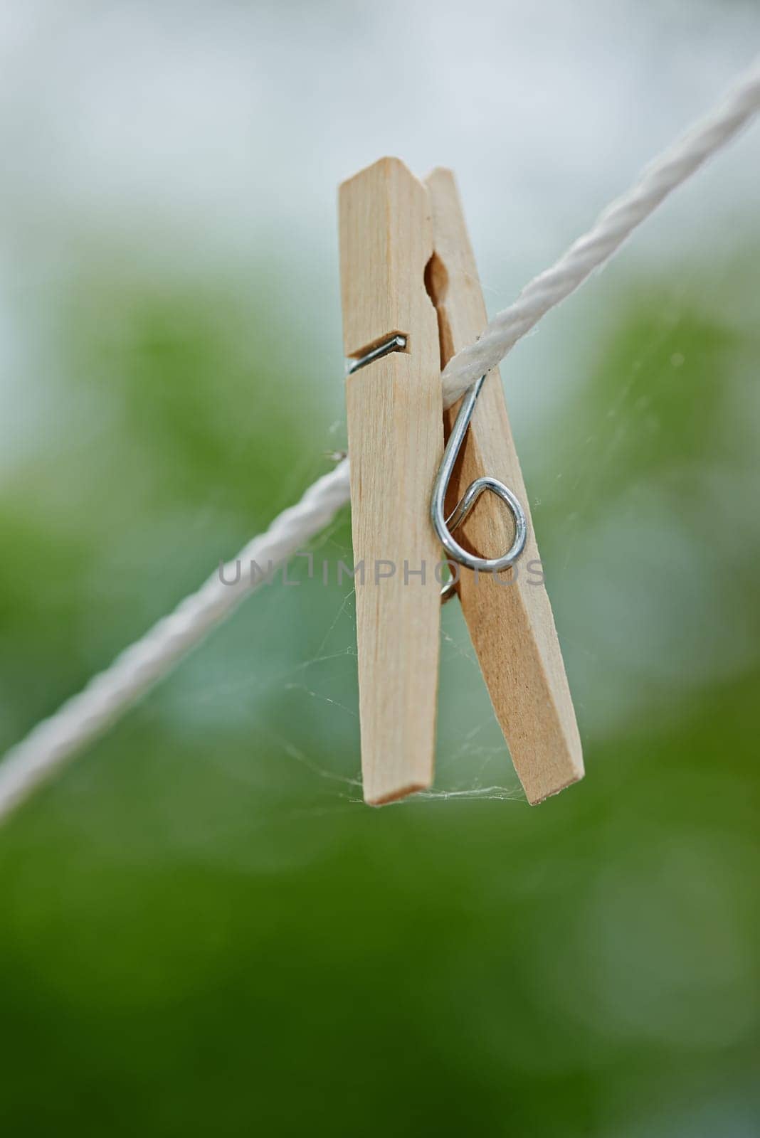 Peg, rope and outdoor for clothes from laundry, clean and dry in nature with plastic clip of closeup. Washing, empty line and wooden tool to hang or pin cloth on wire, fasten and backyard AT house by YuriArcurs