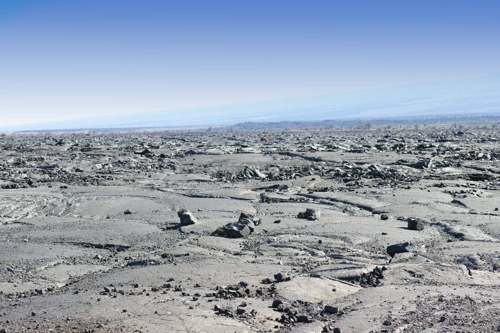 Terrain, mountain and natural landscape with blue sky for rocks, summit and travel destination. Nature, volcano and environment for hiking trail, rough surface and outdoor adventure in Indonesia