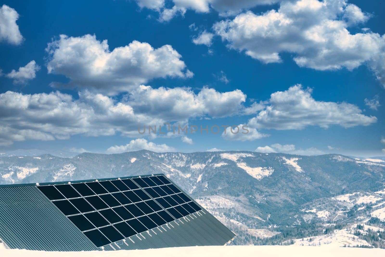 solar panels with the clouds sky. solar panels with sun reflection. background of photovoltaic modules for renewable energy high in mountains. by igor010