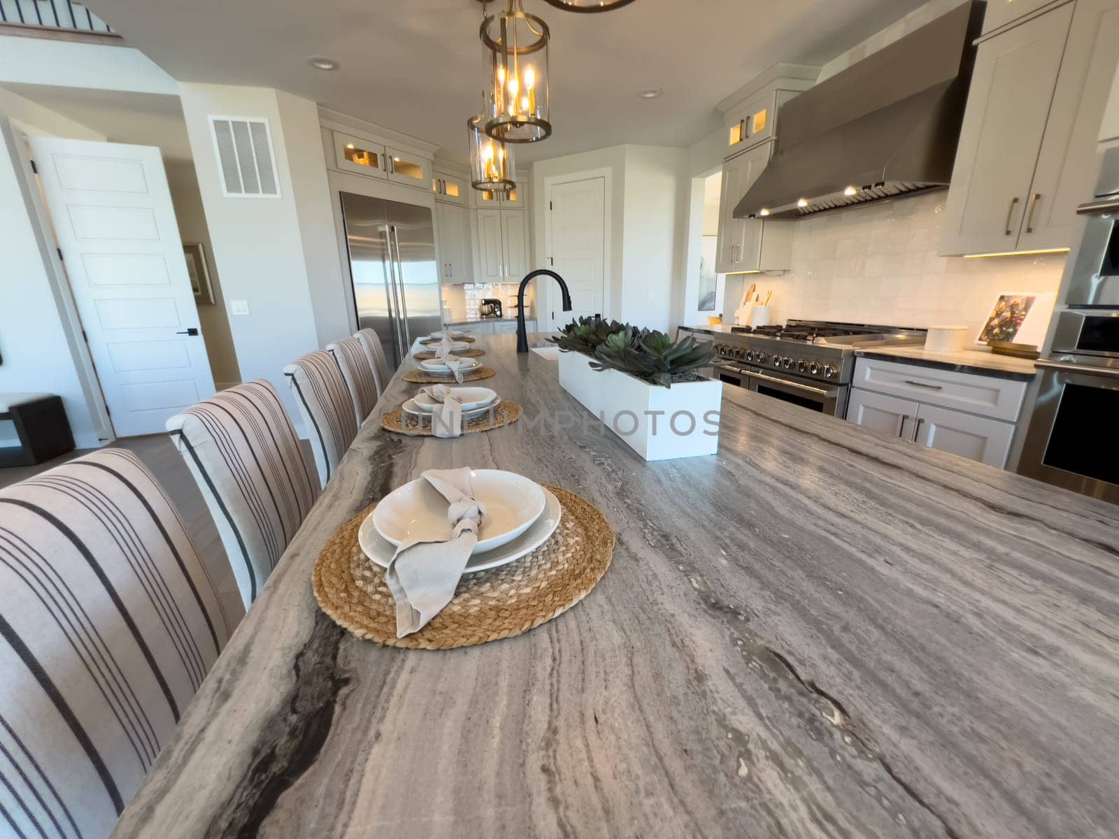 Coastal Elegance Meets Functionality in Spacious Kitchen and Dining Area by arinahabich