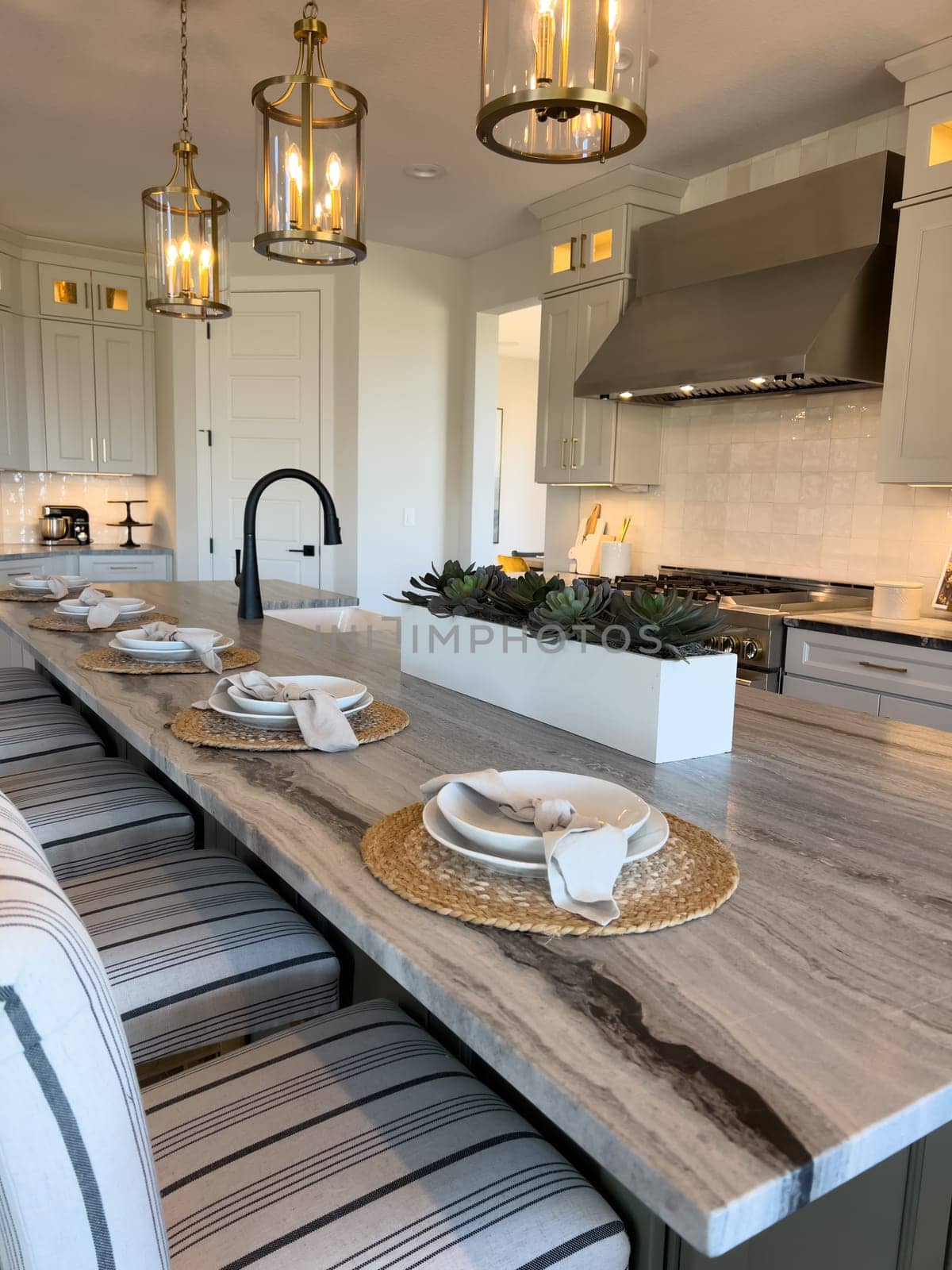 Coastal Elegance Meets Functionality in Spacious Kitchen and Dining Area by arinahabich