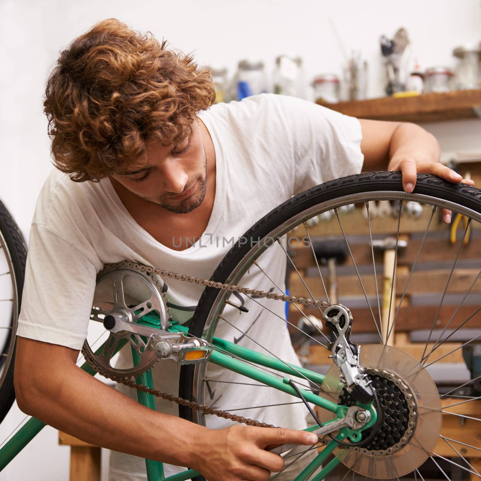 Handyman, fixing and bicycles with with tools at workshop for repair, maintenance with small business. Mechanic, Entrepreneur and garage as expert for bike with equipment for service and upgrade by YuriArcurs