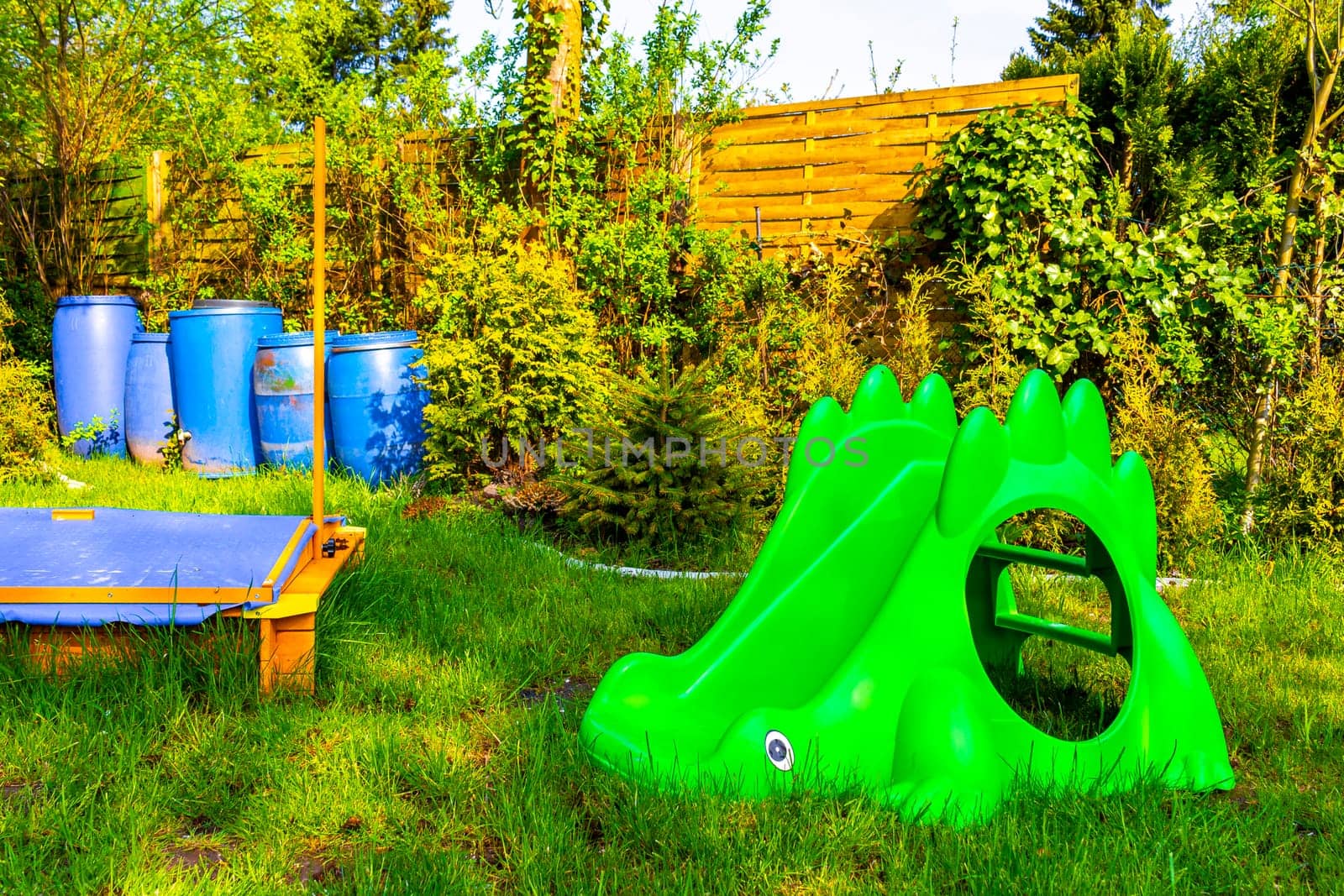 Small colorful playground in the garden in Germany. by Arkadij