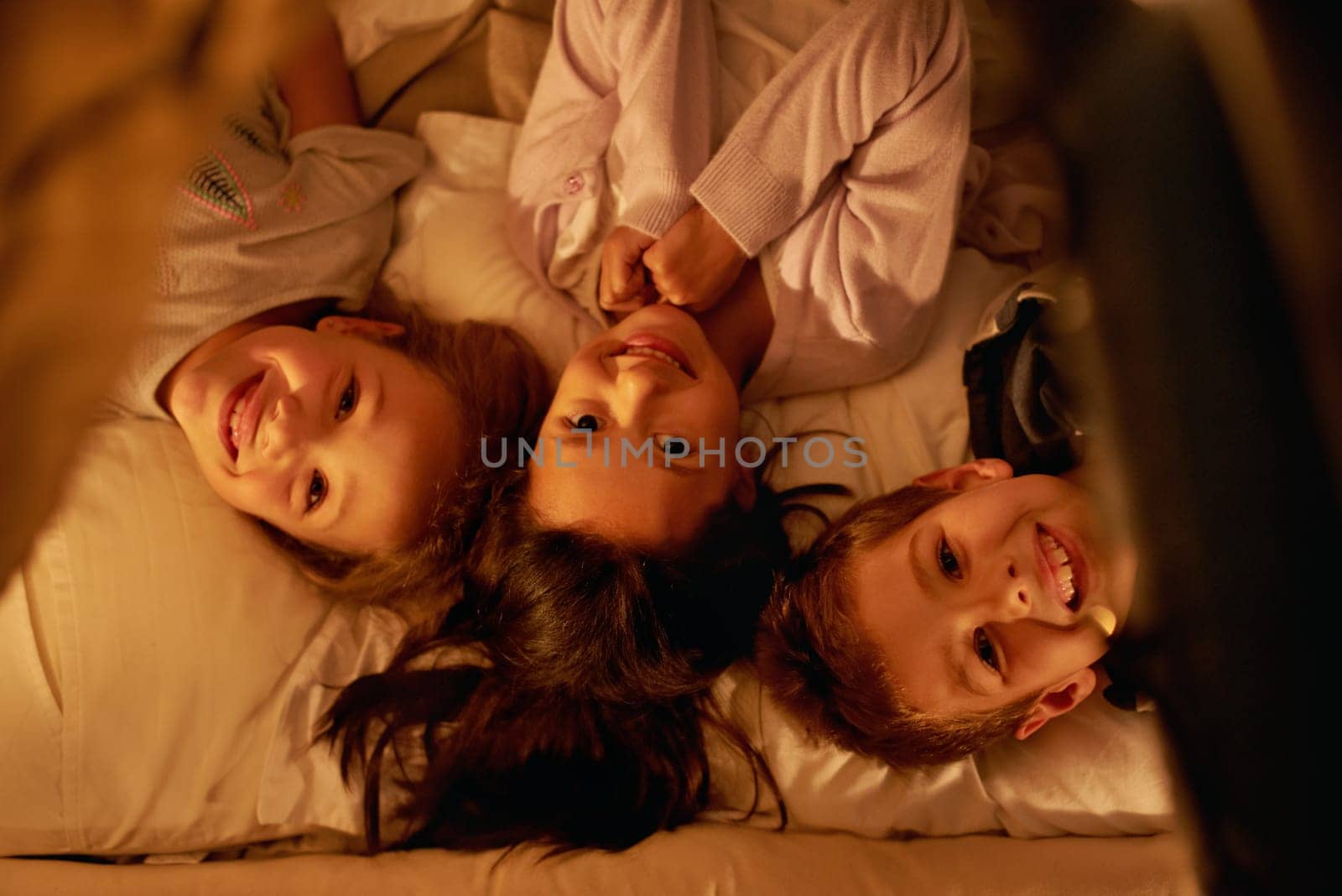 Children, love and portrait of siblings in a bed with fun, support and trust while bonding at home together. Family, night and face of kids in a bedroom for evening games, playing or indoor camping.