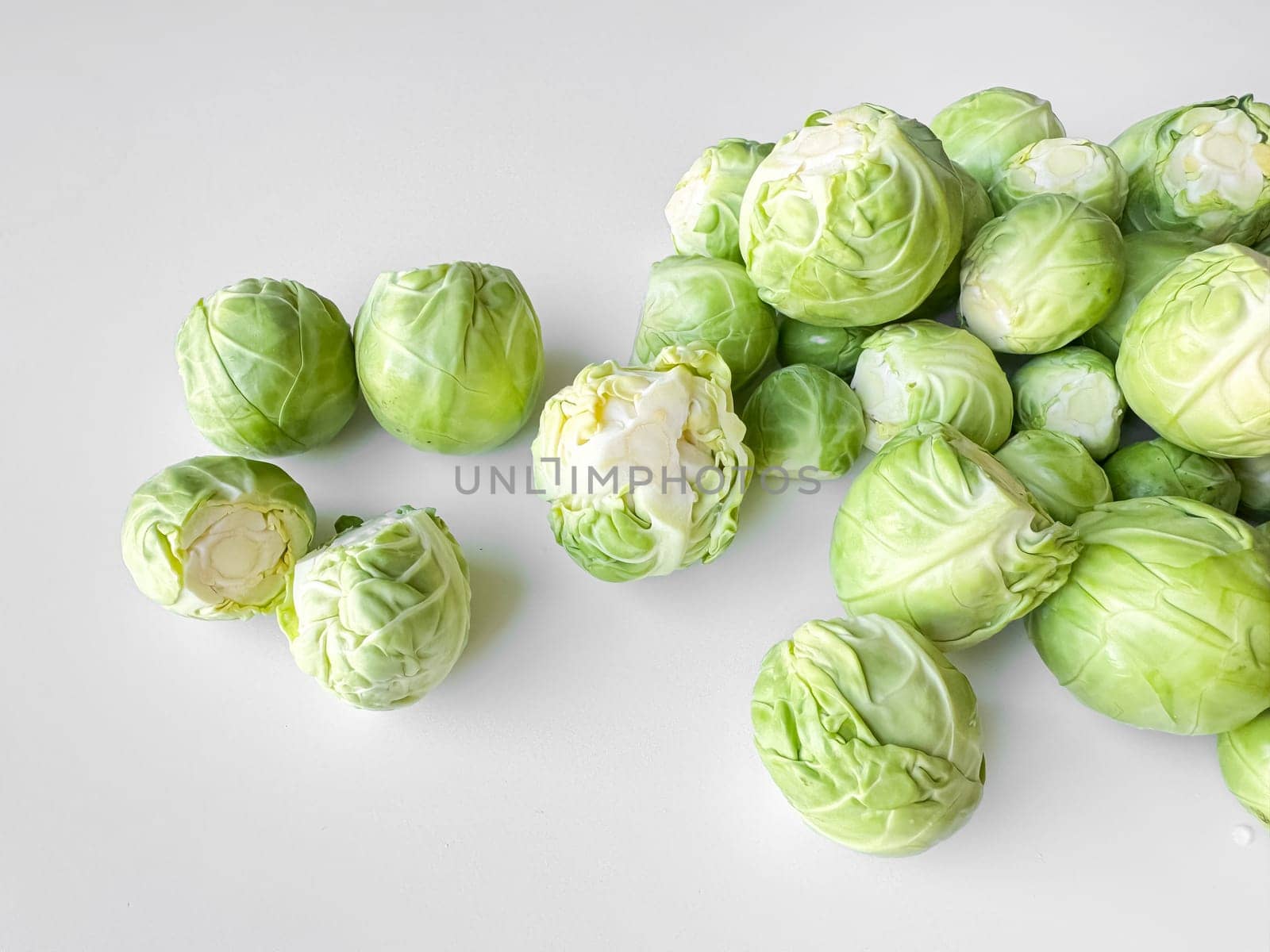 Fresh Brussels sprouts on white background, healthy green vegetable concept with copy space. High quality photo