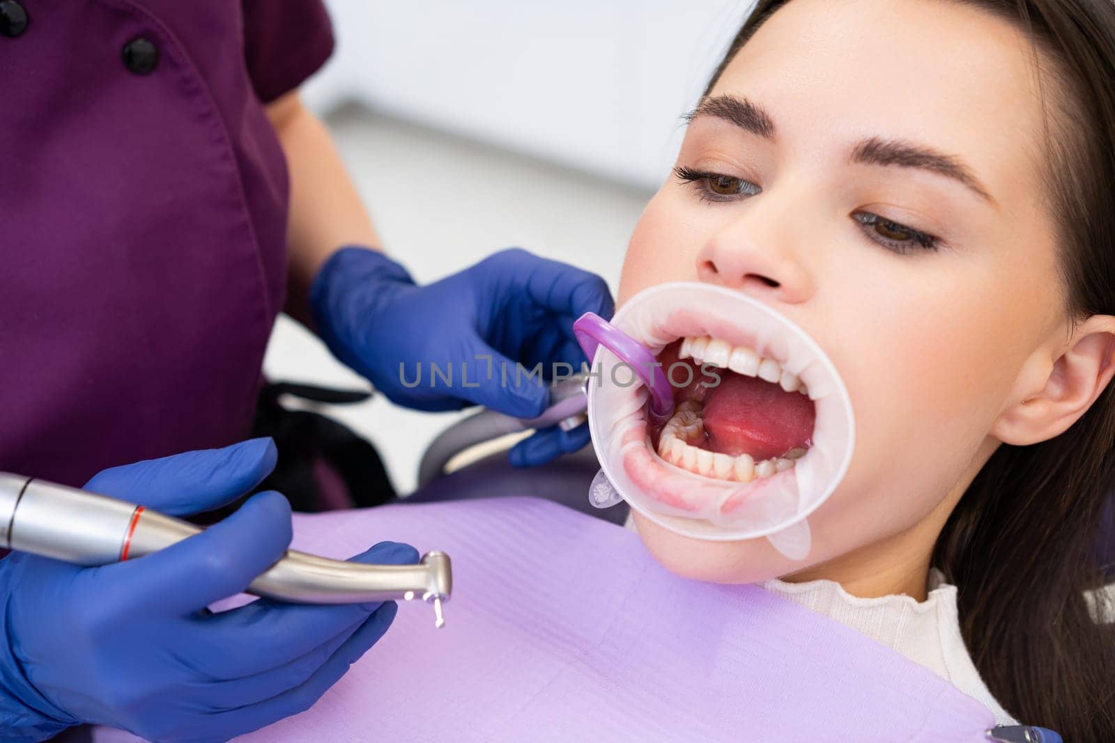 Professional dentist examines patients teeth in stomatology clinic by vladimka