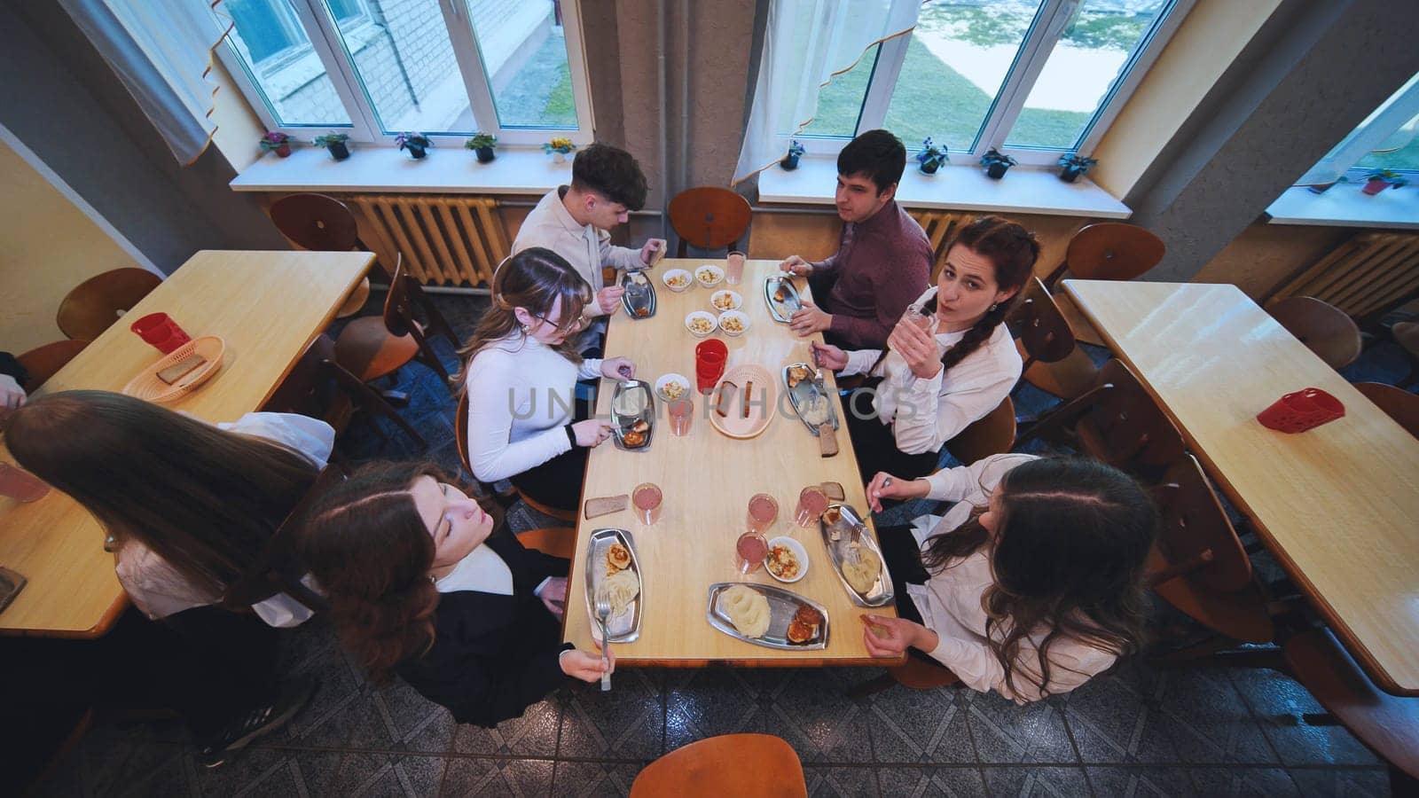 Children eating in the school cafeteria. by DovidPro