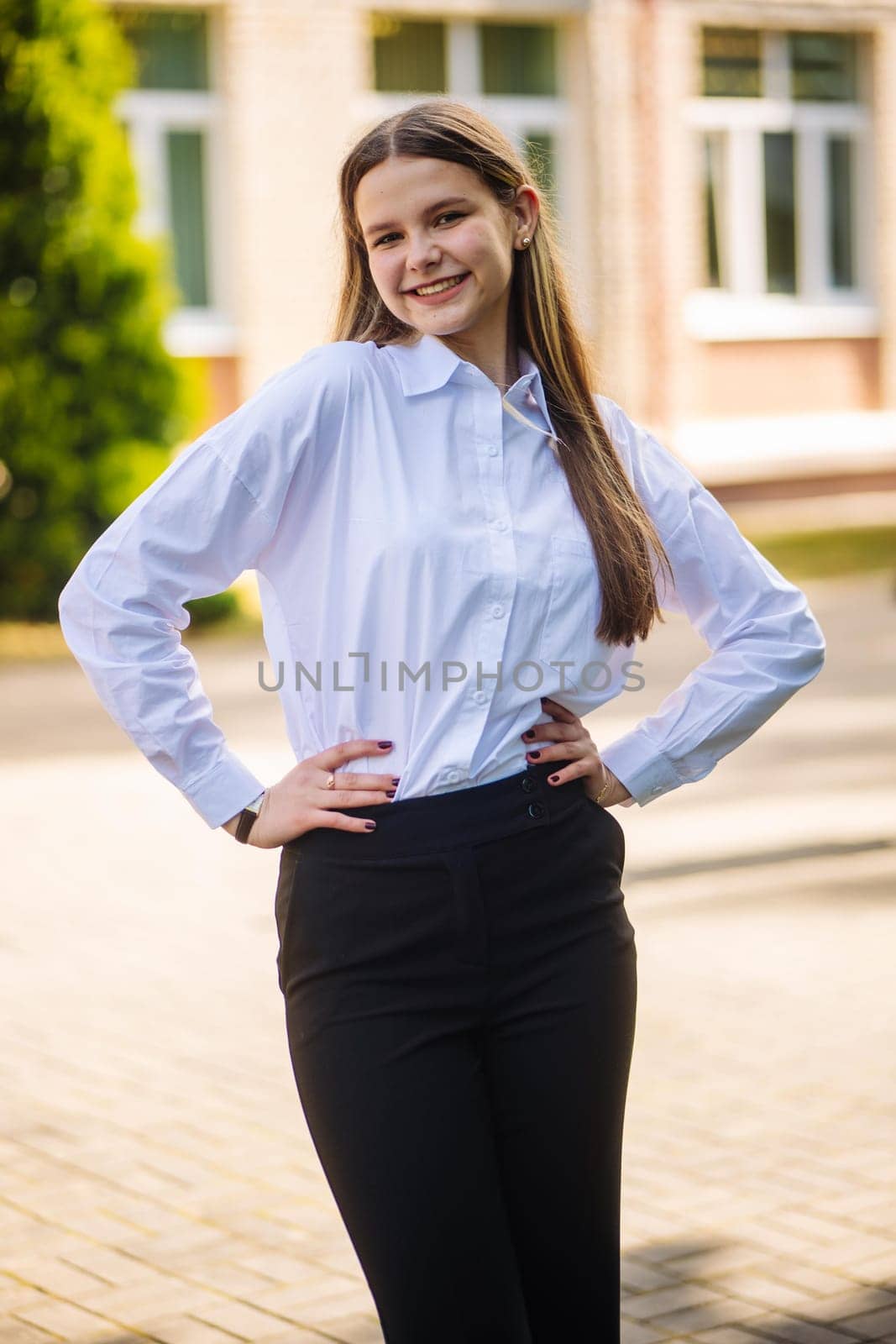 Portrait of a high school student against the backdrop of the school. by DovidPro