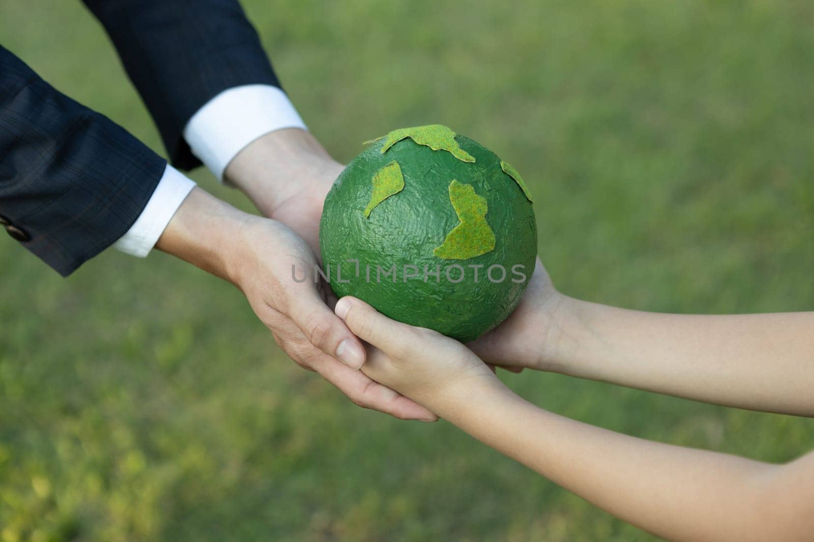 Businessman hand giving Earth globe to little boy as Earth day concept. Gyre by biancoblue