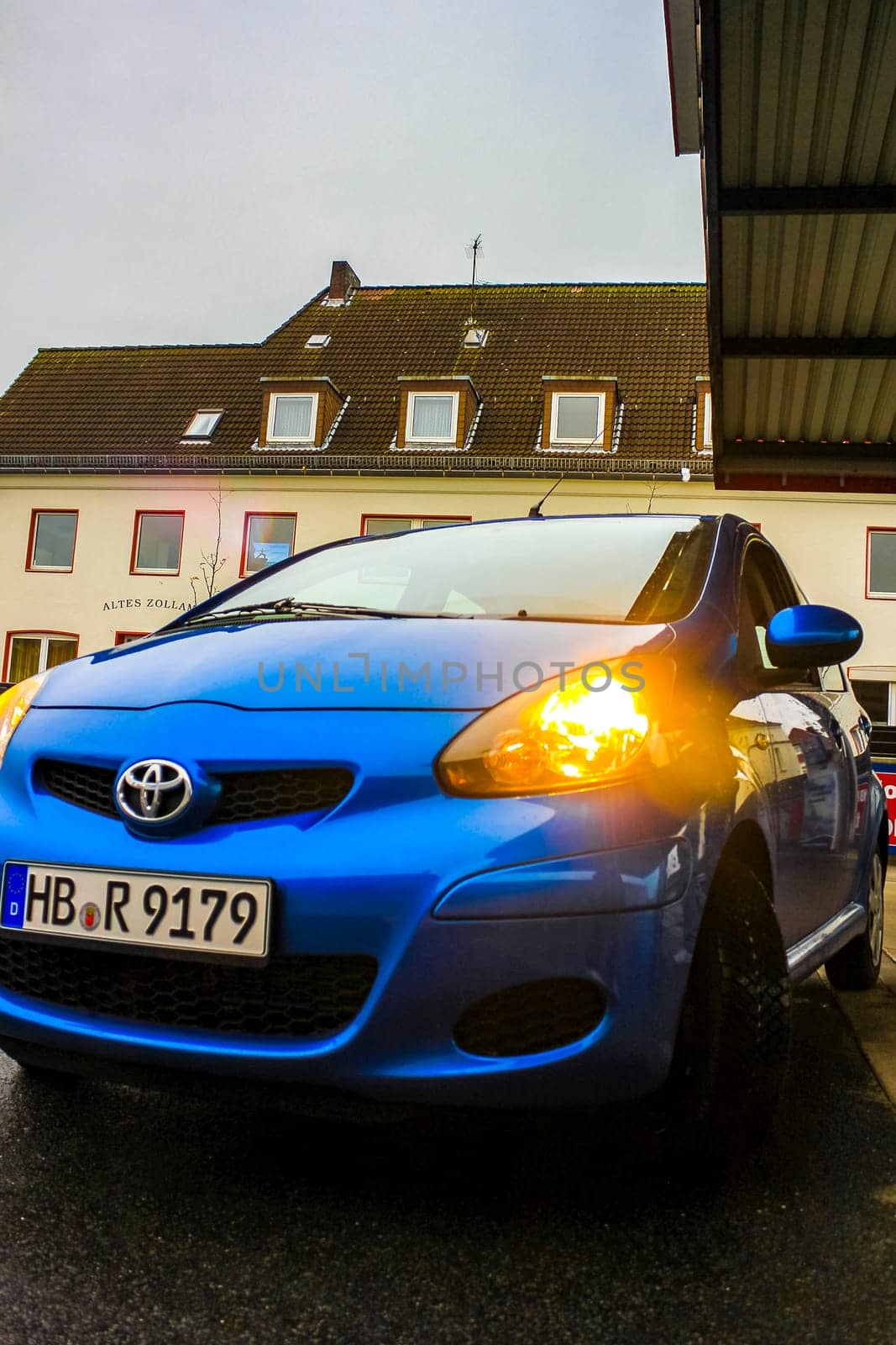 Small blue car vehicle parked in Germany. by Arkadij